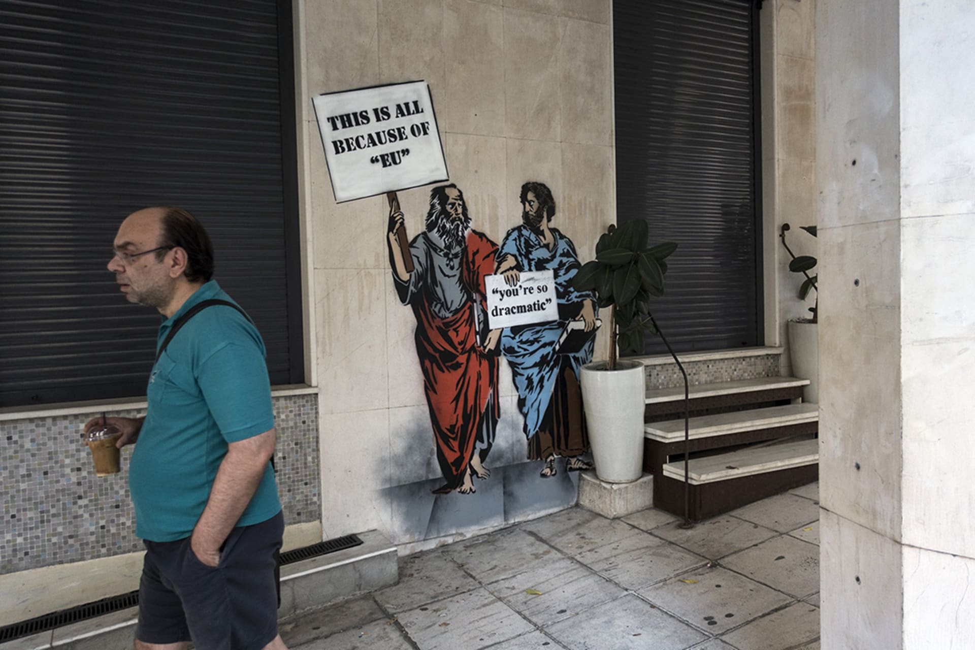 Closed shops in central Athens in August 2018, covered in protest graffiti against the country’s EU creditors. 
