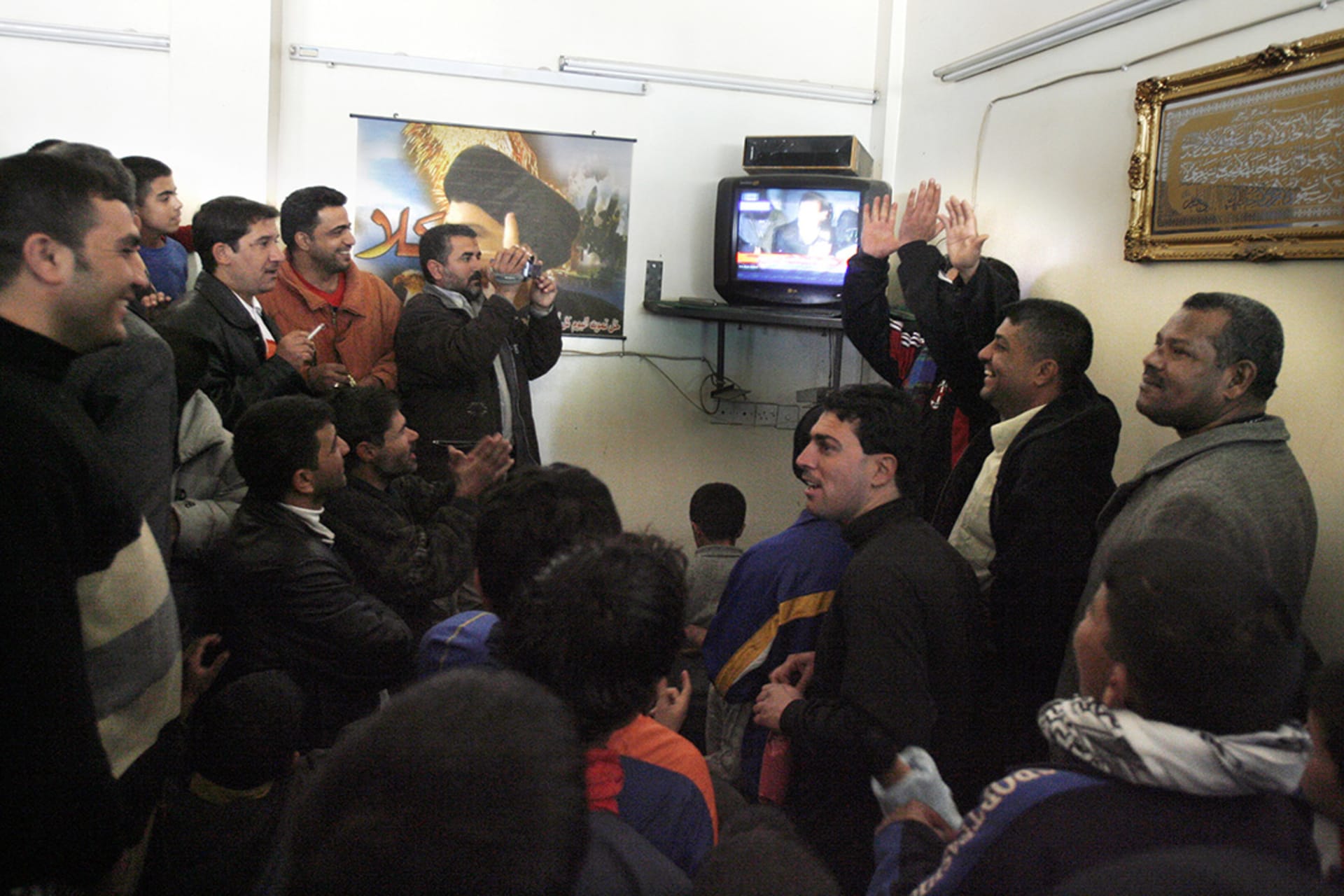 Iraqi Shiites cheer televised footage of Saddam’s execution. 
