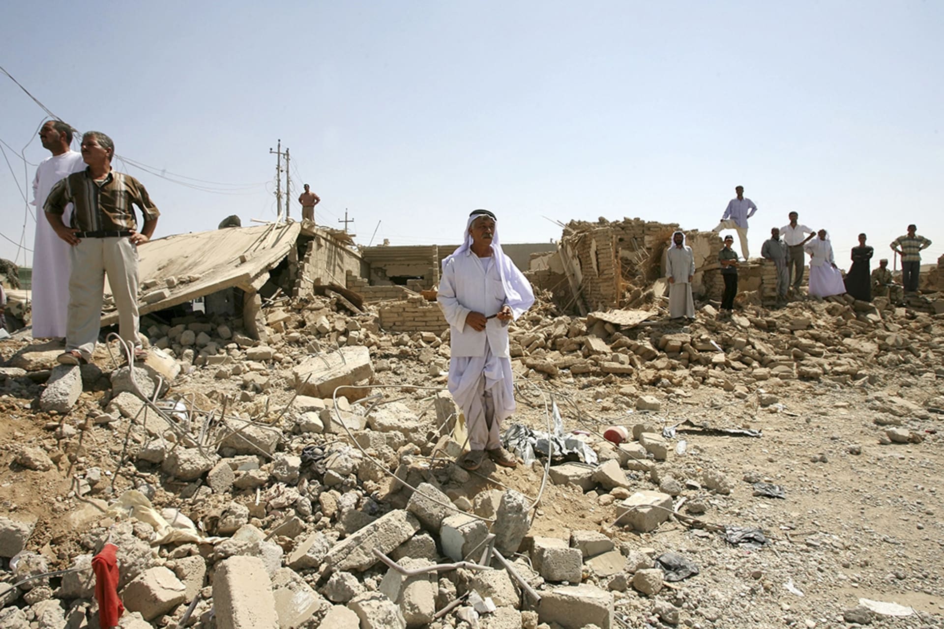 Men survey the site of a suicide bombing in Til Ezer, also known as Qahtaniya, one of two Yazidi villages attacked on August 14, 2007. 
