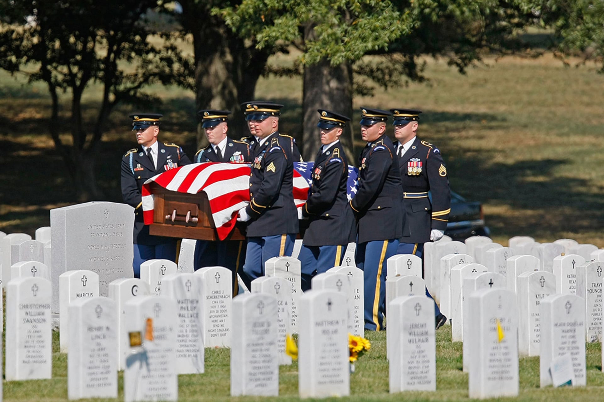 A military honor guard carries the casket of Army Sergeant Michael C. Hardegree during his funeral in Arlington, Virginia. 
