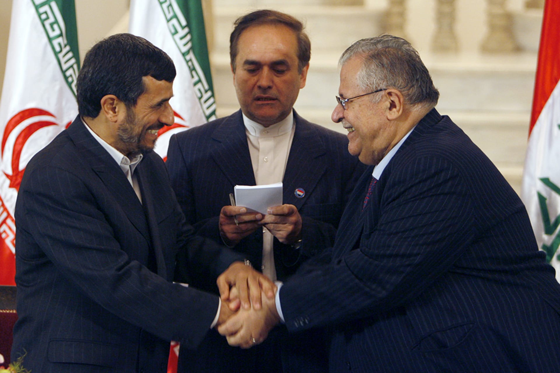 Iraqi President Jalal Talabani, right, shakes hands with Iranian President Mahmoud Ahmadinejad upon the latter’s arrival in Baghdad. 
