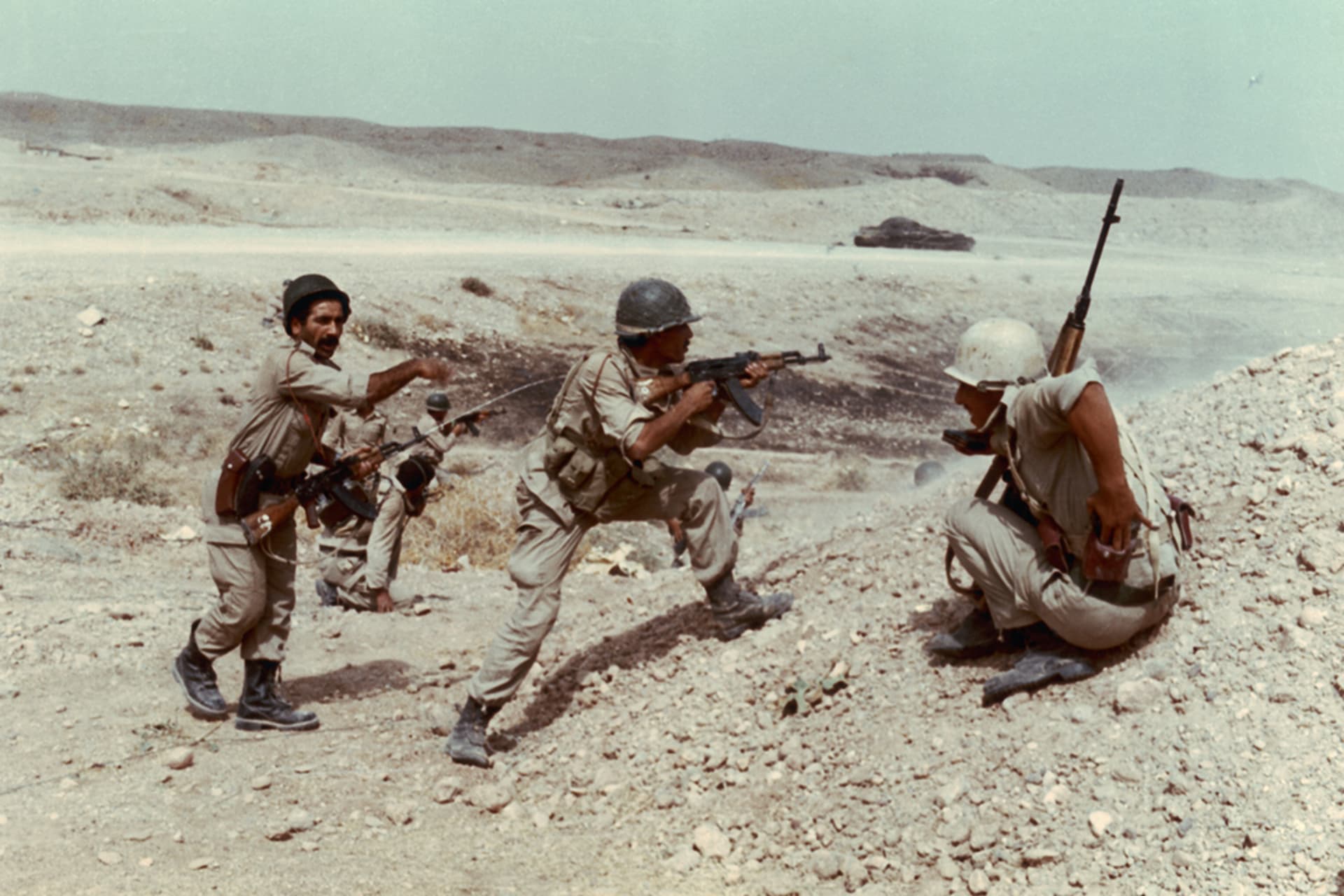 Iraqi soldiers fire at Iranian troops during the Iran-Iraq War. 