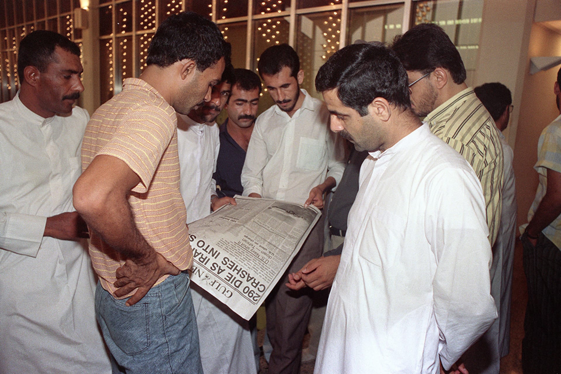 Iranian men in Dubai wait for news of their loved ones on the downed Iranian Air jet. 