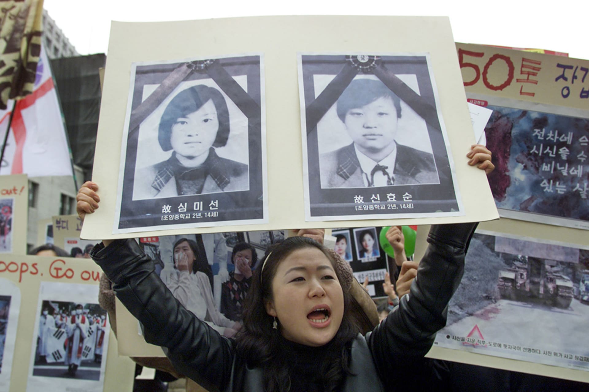 A protester shouts anti-American slogans while holding a poster of the two students accidentally killed by U.S. officers in Seoul, South Korea, on December 3, 2002. Lee Jae-Won/Reuters