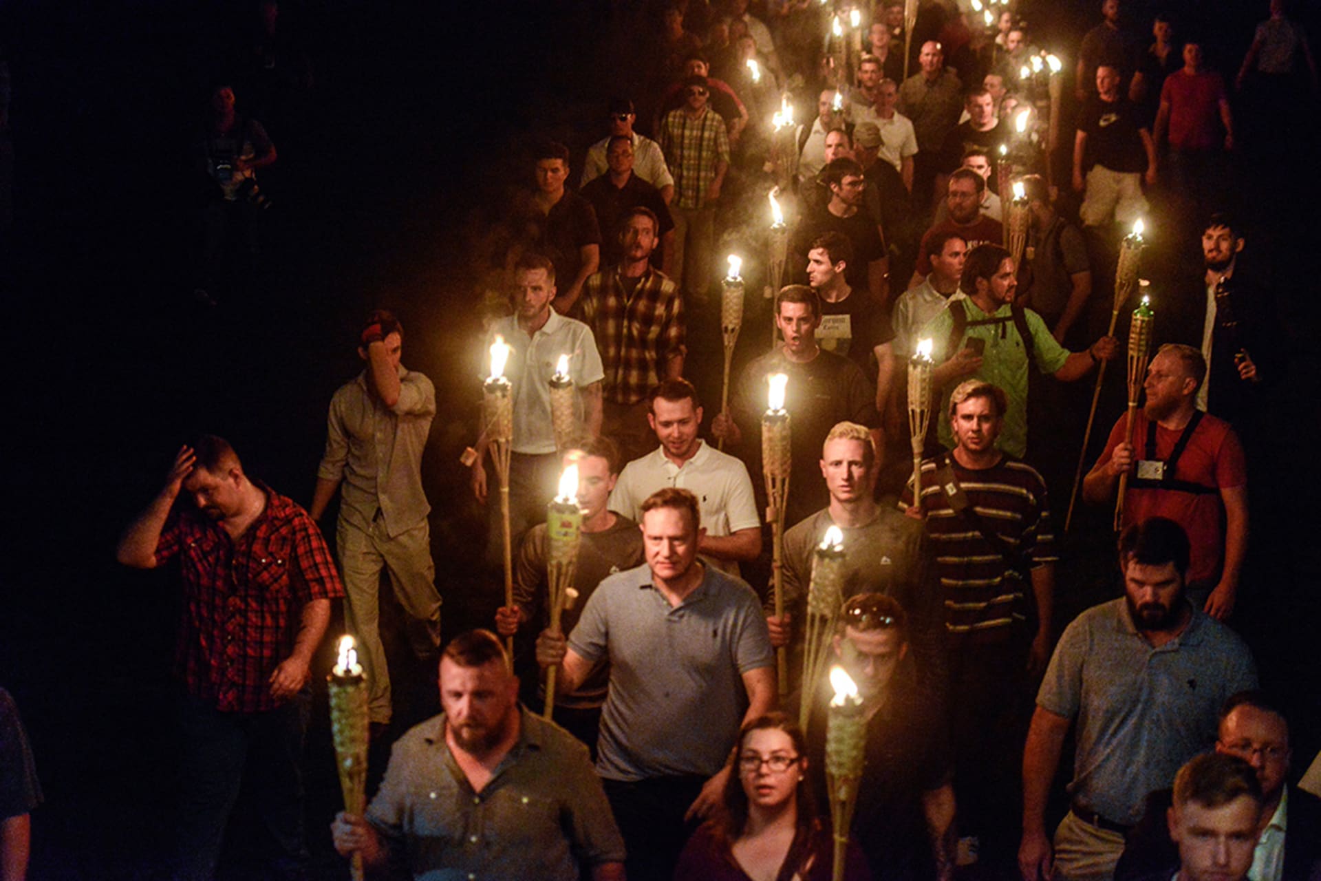 White nationalists march on the grounds of the University of Virginia ahead of the Unite the Right rally in Charlottesville, Virginia. 

