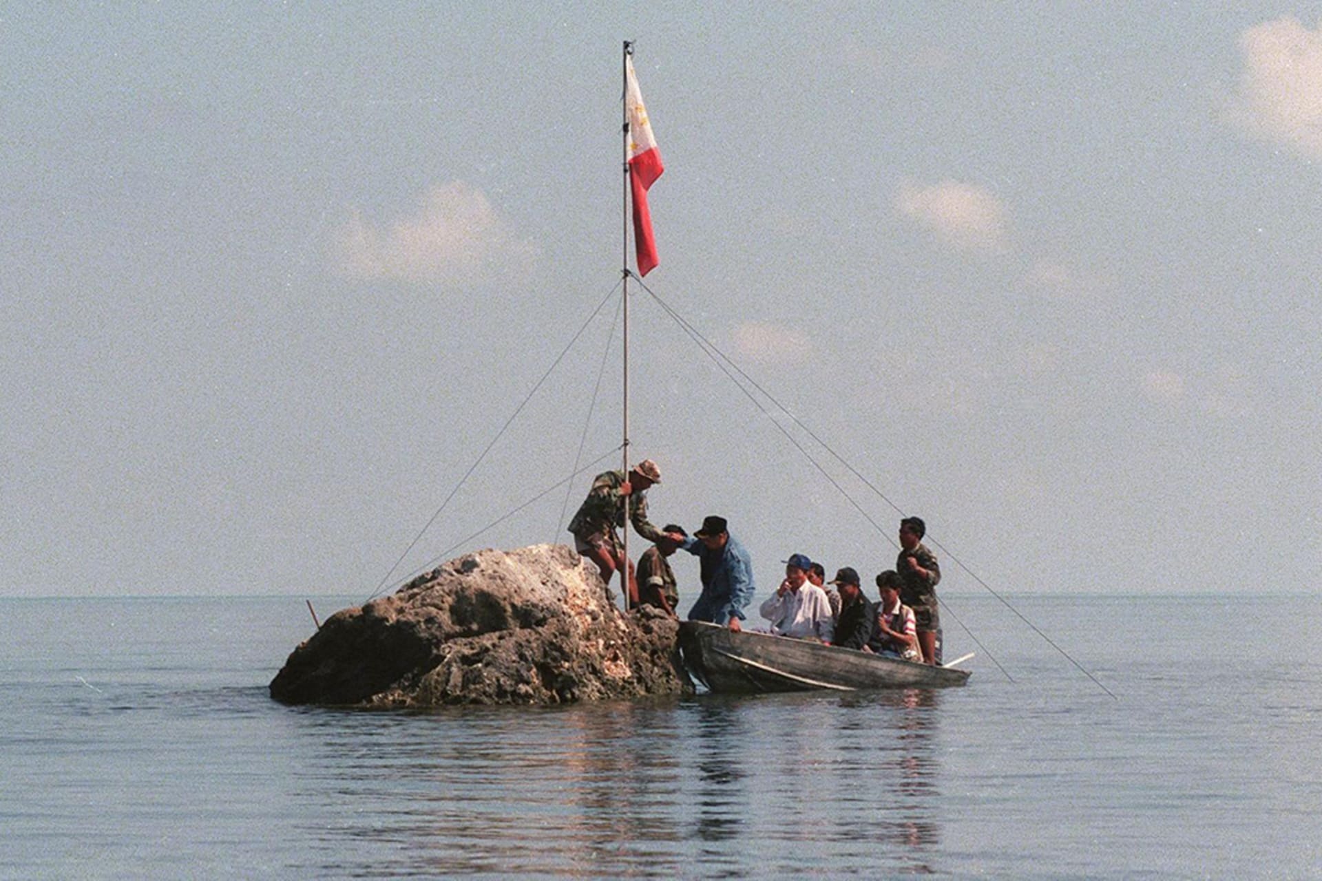 Philippine Navy personnel plant a flag at the disputed Scarborough Shoal. AFP/Getty Images