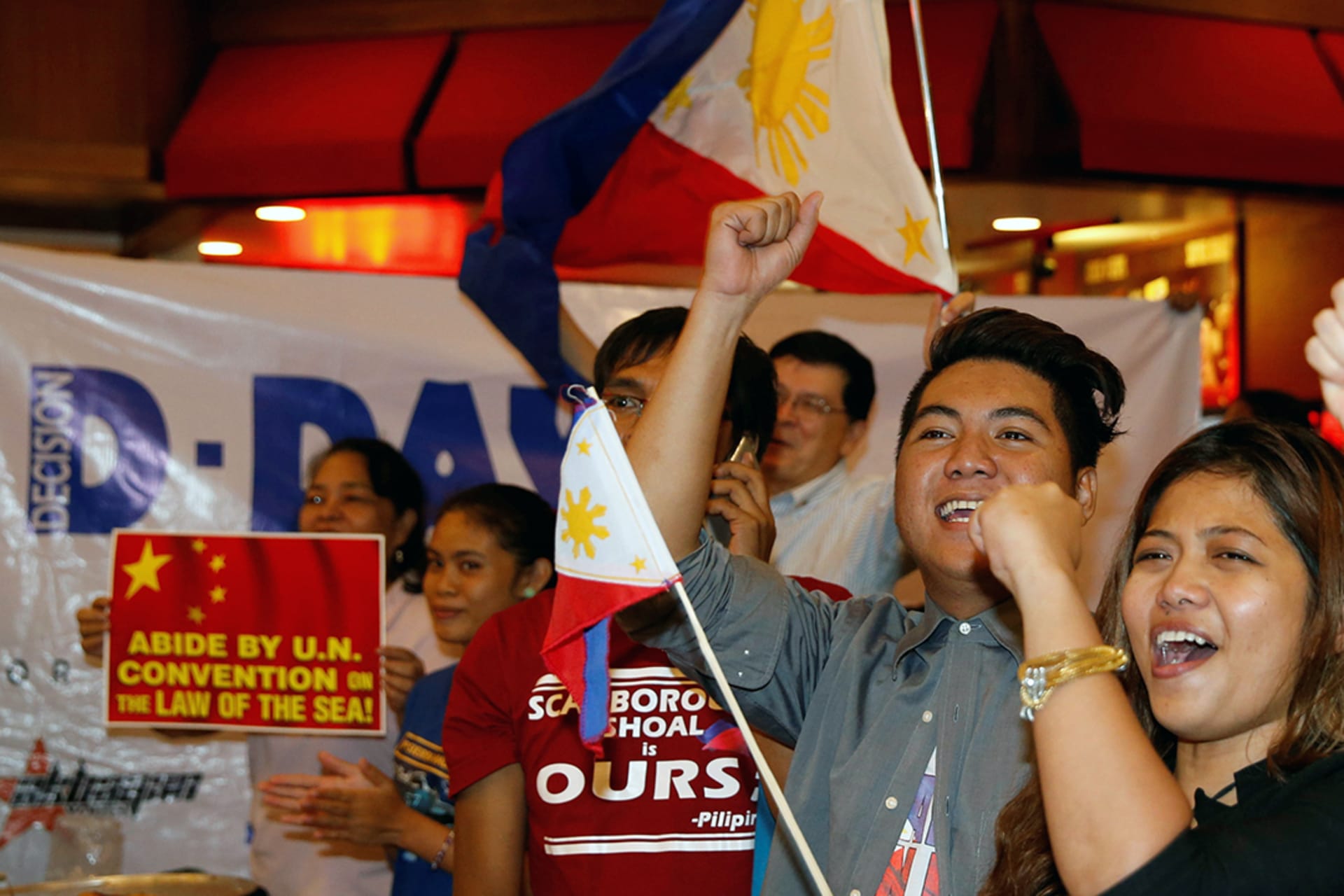 Activists who travelled to disputed Scarborough Shoal and were blocked by Chinese Coastguard a few months prior react after a ruling on the disputed South China Sea by an arbitration court in The Hague, Manila, Philippines, July 12, 2016. Erik de Castro/Reuters