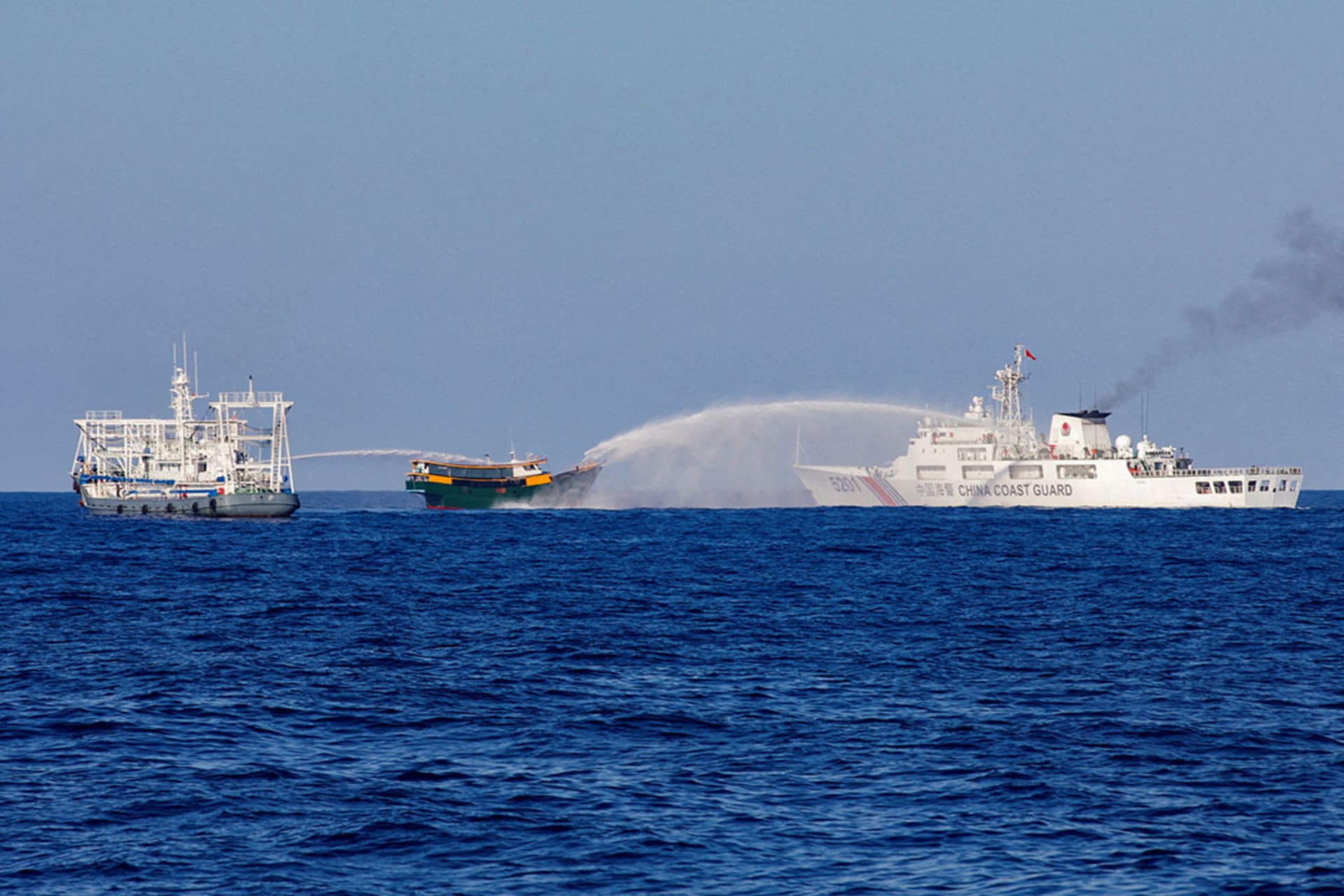 Chinese Coast Guard vessels fire water cannons towards a Philippine vessel on a resupply mission to the Second Thomas Shoal on May 4, 2024. Adrian Portugal/Reuters