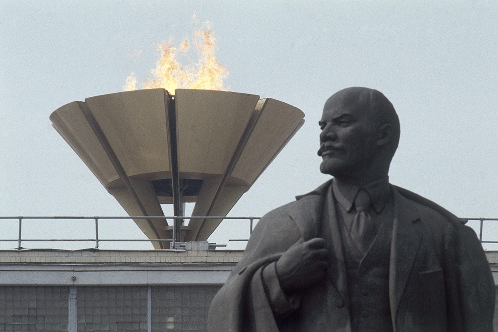 The Olympic flame burns above a statue of former Soviet leader Vladimir Lenin in Moscow. AP Photo