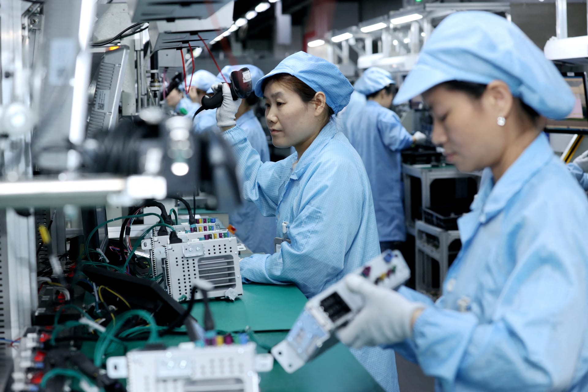<p>Workers assembling automotive navigation products at a factory in Suqian, Jiangsu Province, China on April 9, 2025.</p>
