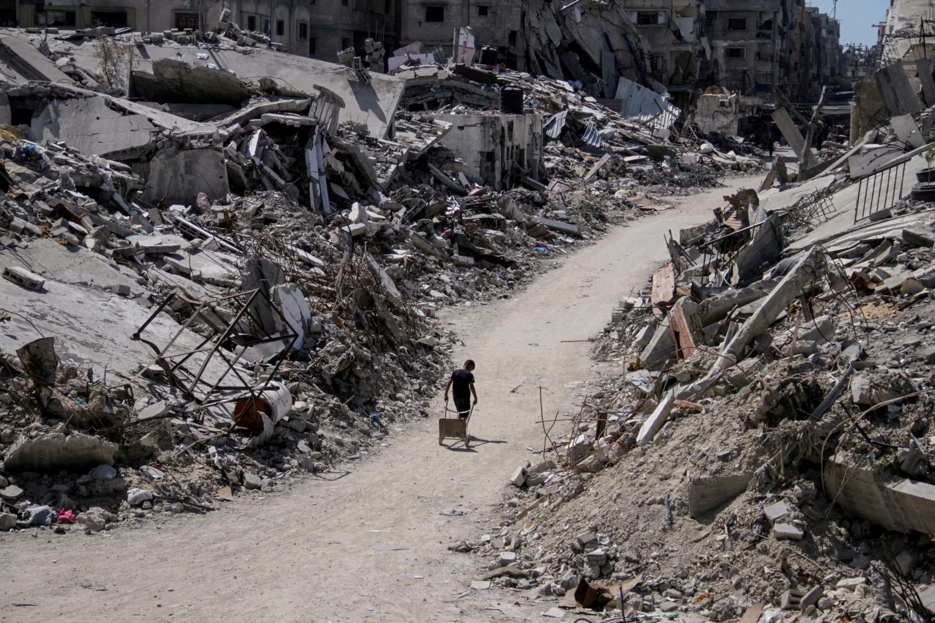 <p>A Palestinian walks among the rubble of damaged buildings, which were destroyed during Israel’s military offensive, amid the ongoing conflict between Israel and Hamas, in Beit Lahia in the northern Gaza Strip, June 12, 2024.</p>