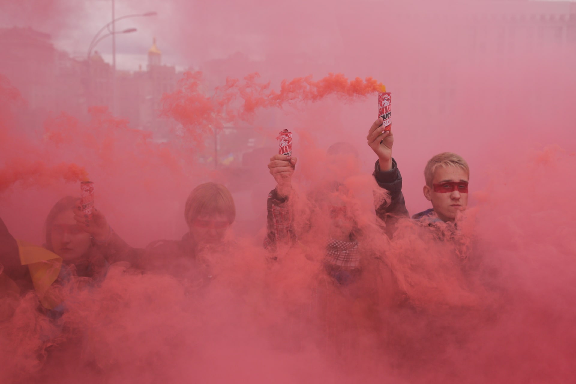 <p>People hold flares during a protest at Independence Square in Kyiv.</p>