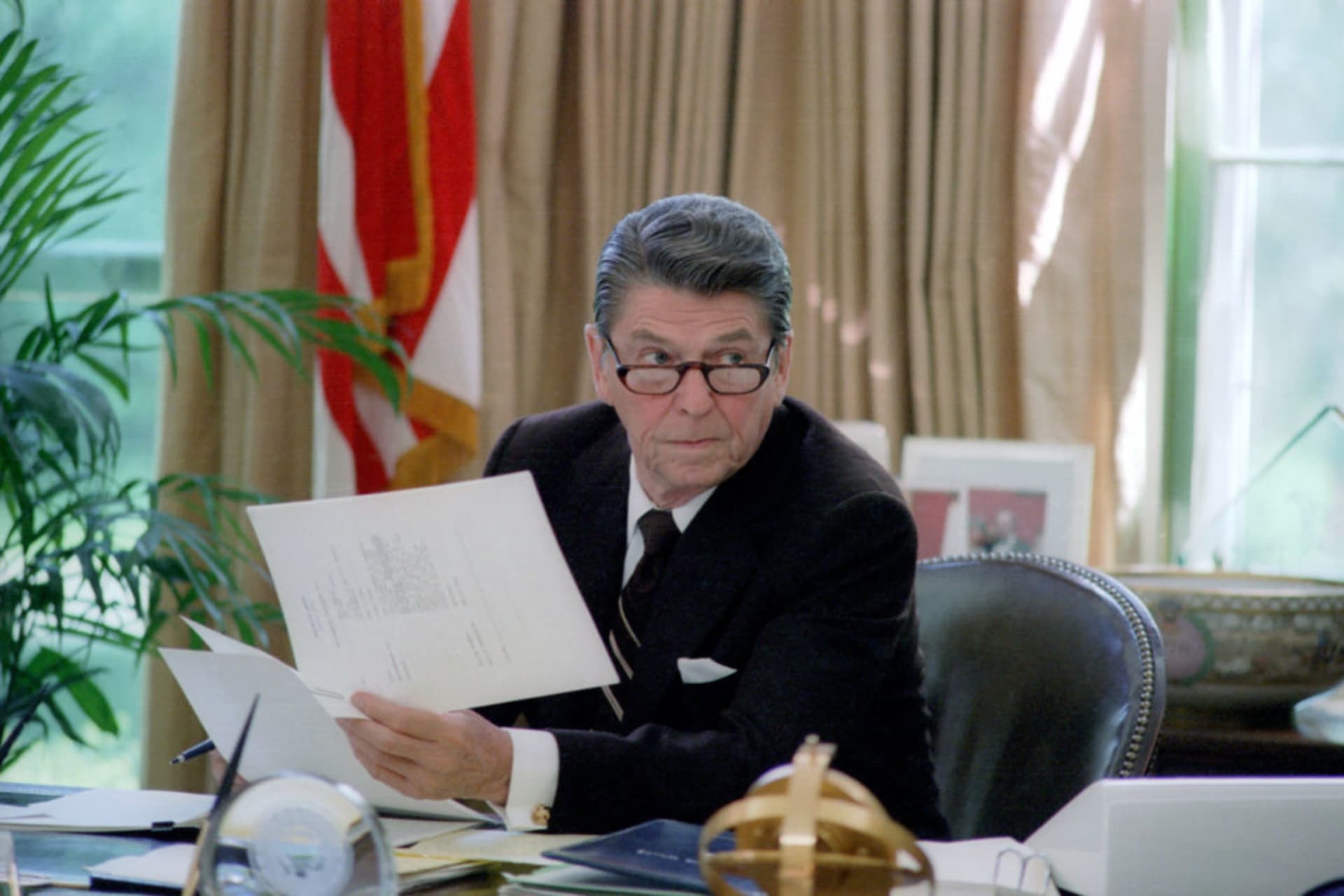 <p>President Ronald Reagan at his desk in the Oval Office in Washington, DC. HUM Images/Universal Images Group/Getty Images</p>
