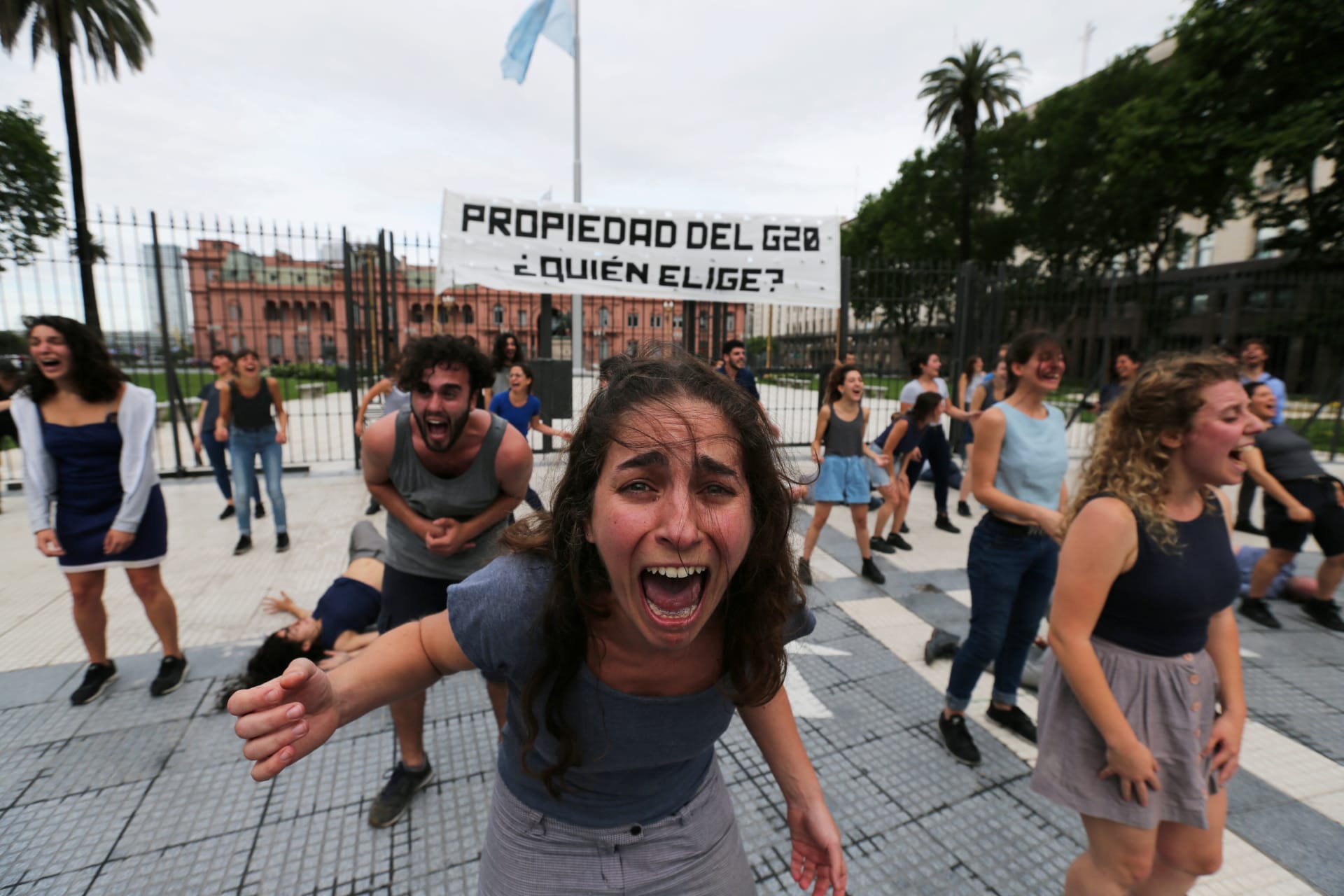 <p>Demonstrators perform outside the presidential palace, ahead of the Group 20 summit, in Buenos Aires, Argentina November 29, 2018. The writing on the banner reads “Property of the G20, who chooses?”</p>
