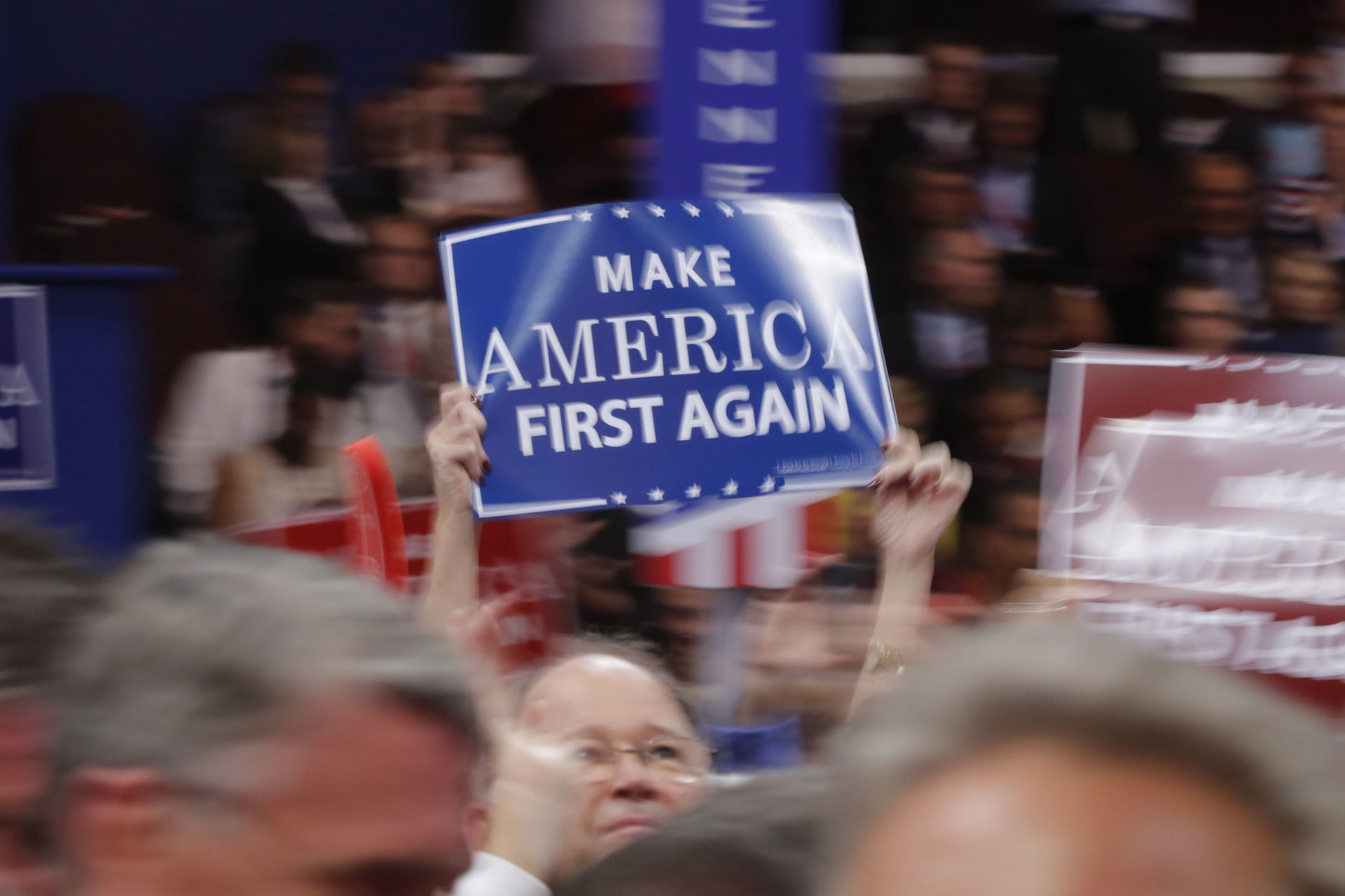 <p>A delegate waves a “Make America First Again” sign on the floor during the third session of the Republican National Convention in Cleveland, Ohio, U.S. July 20, 2016.</p>
