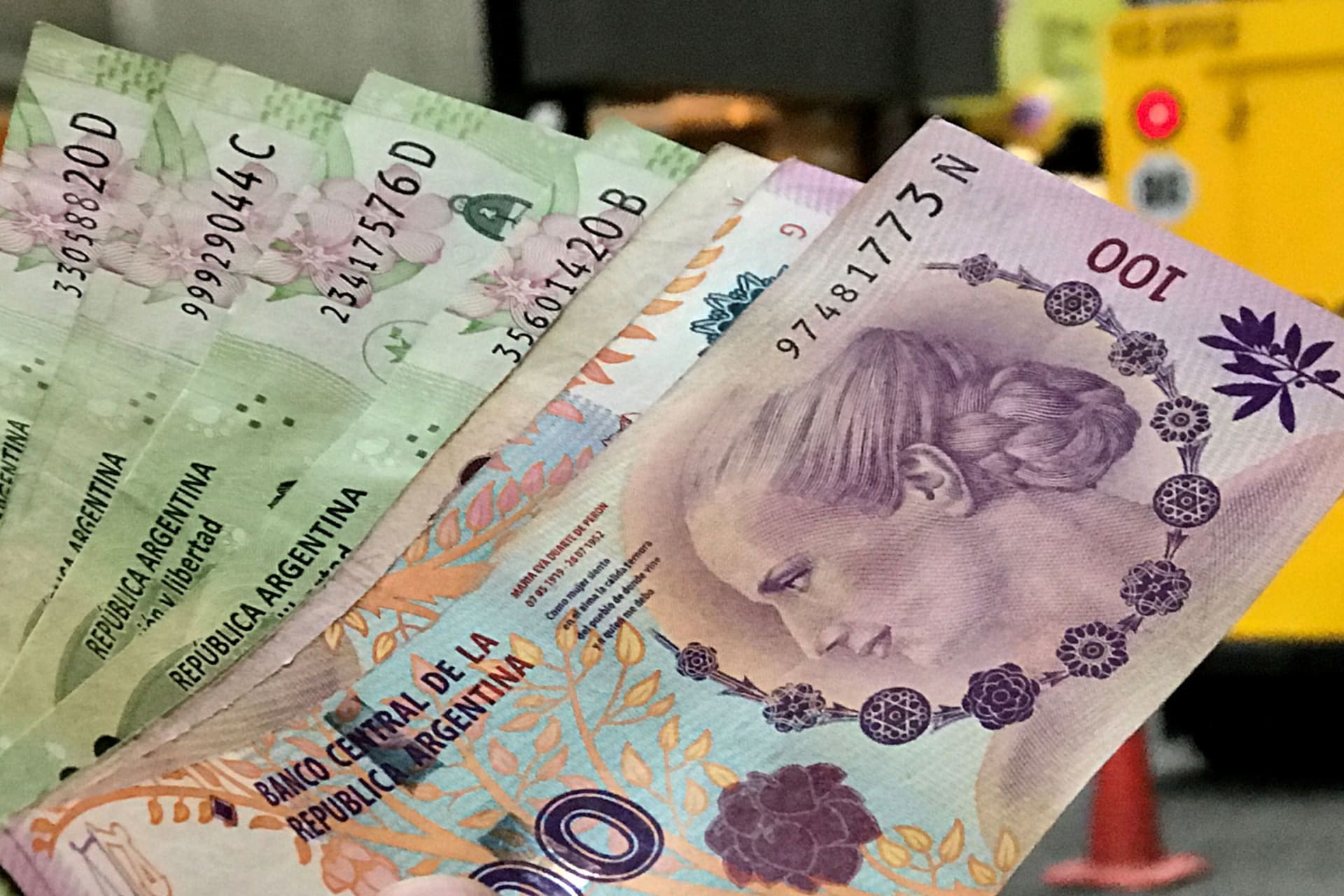 <p>A man shows Argentine pesos outside a bank in Buenos Aires’ financial district, August 30, 2018.</p>