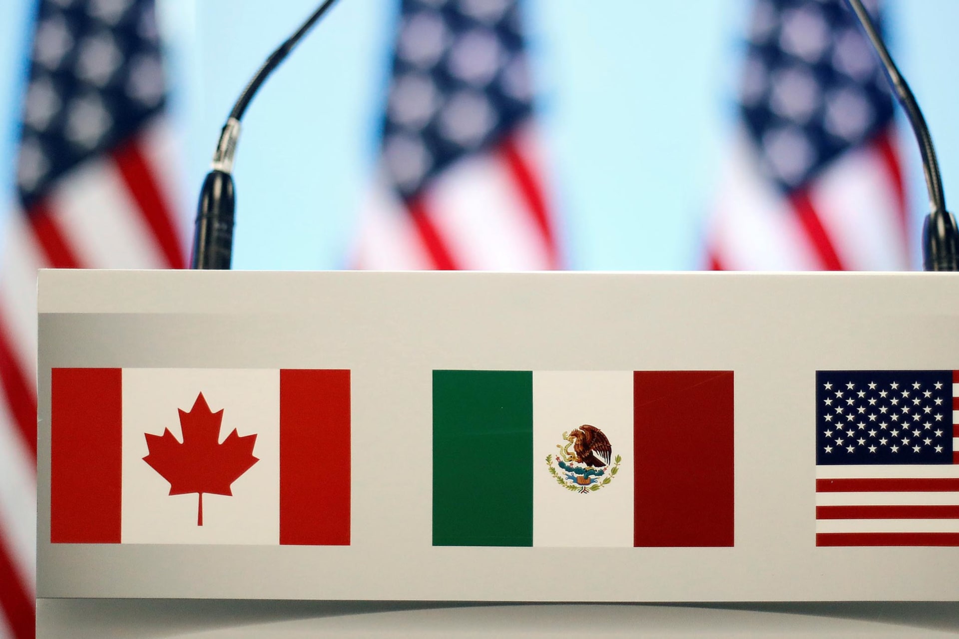 <p>The flags of Canada, Mexico, and the U.S. are seen on a lectern before a joint news conference on the closing of the seventh round of NAFTA talks in Mexico City, Mexico, March 5, 2018.</p>
