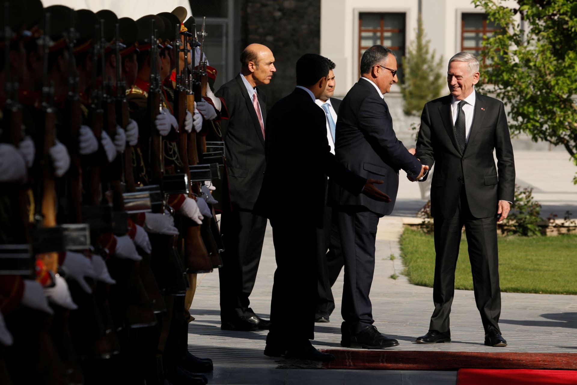 <p>U.S. secretary of defense James Mattis is greeted by Presidential Palace staff in Kabul, Afghanistan as he prepares to meet Afghan president Ashraf Ghani in April 2017.</p>

