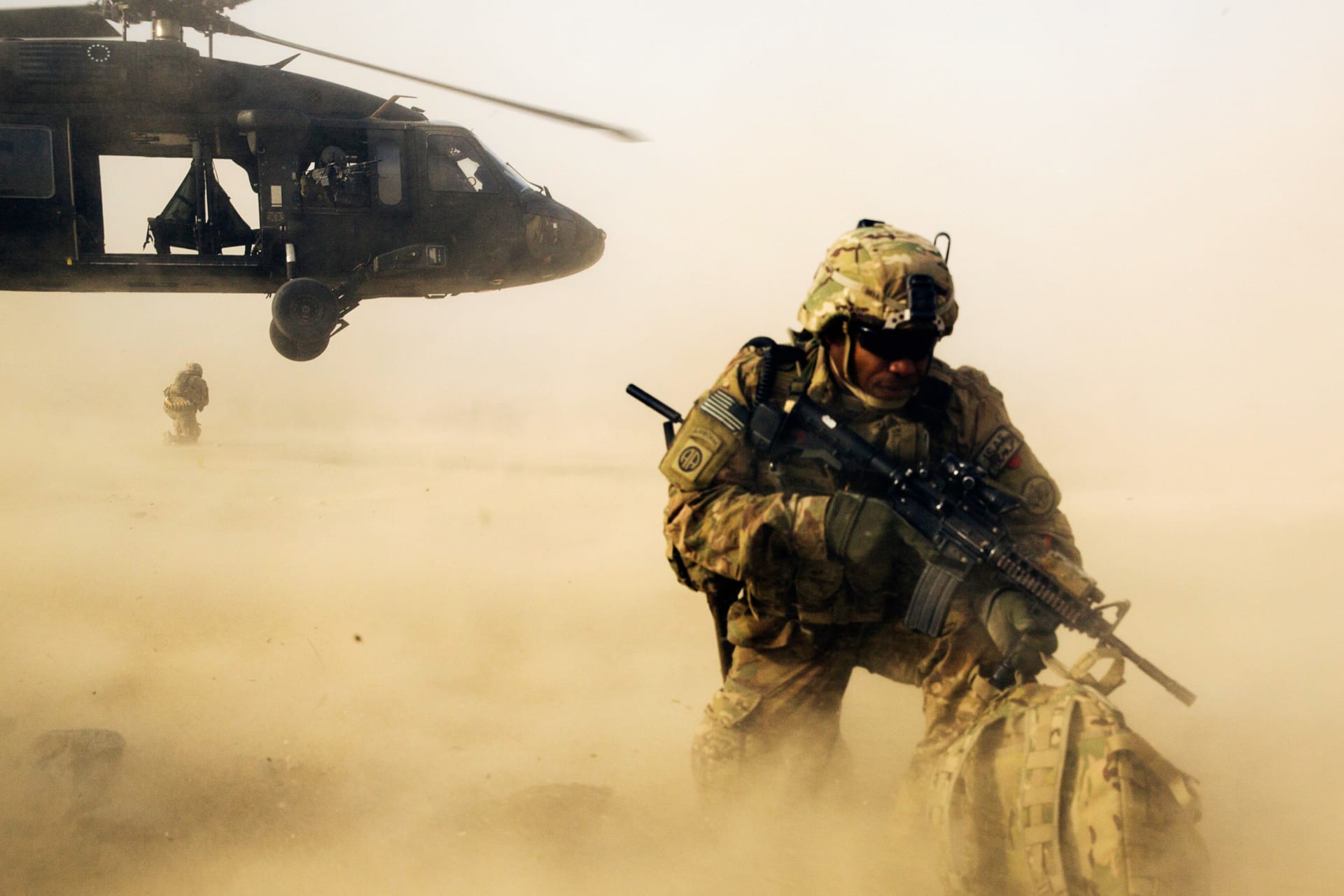 <p>A U.S. soldier  shields himself from the rotor wash of a Blackhawk helicopter after being dropped off for a mission with the Afghan police in the Nangarhar province of Afghanistan.</p>
