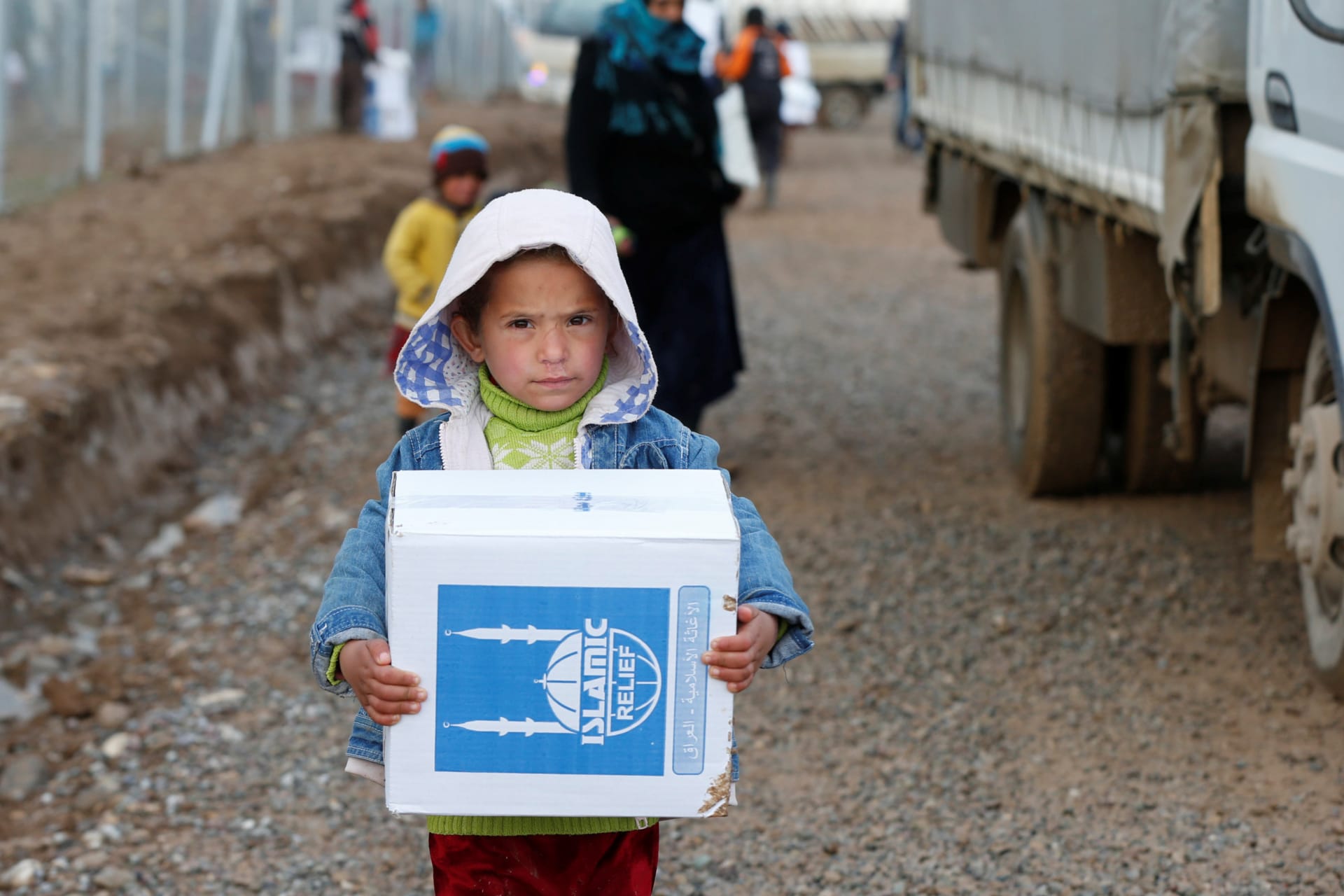 <p>A displaced Iraqi child who fled the Islamic State received humanitarian aid supplies at Al Khazer camp, Iraq.</p>

