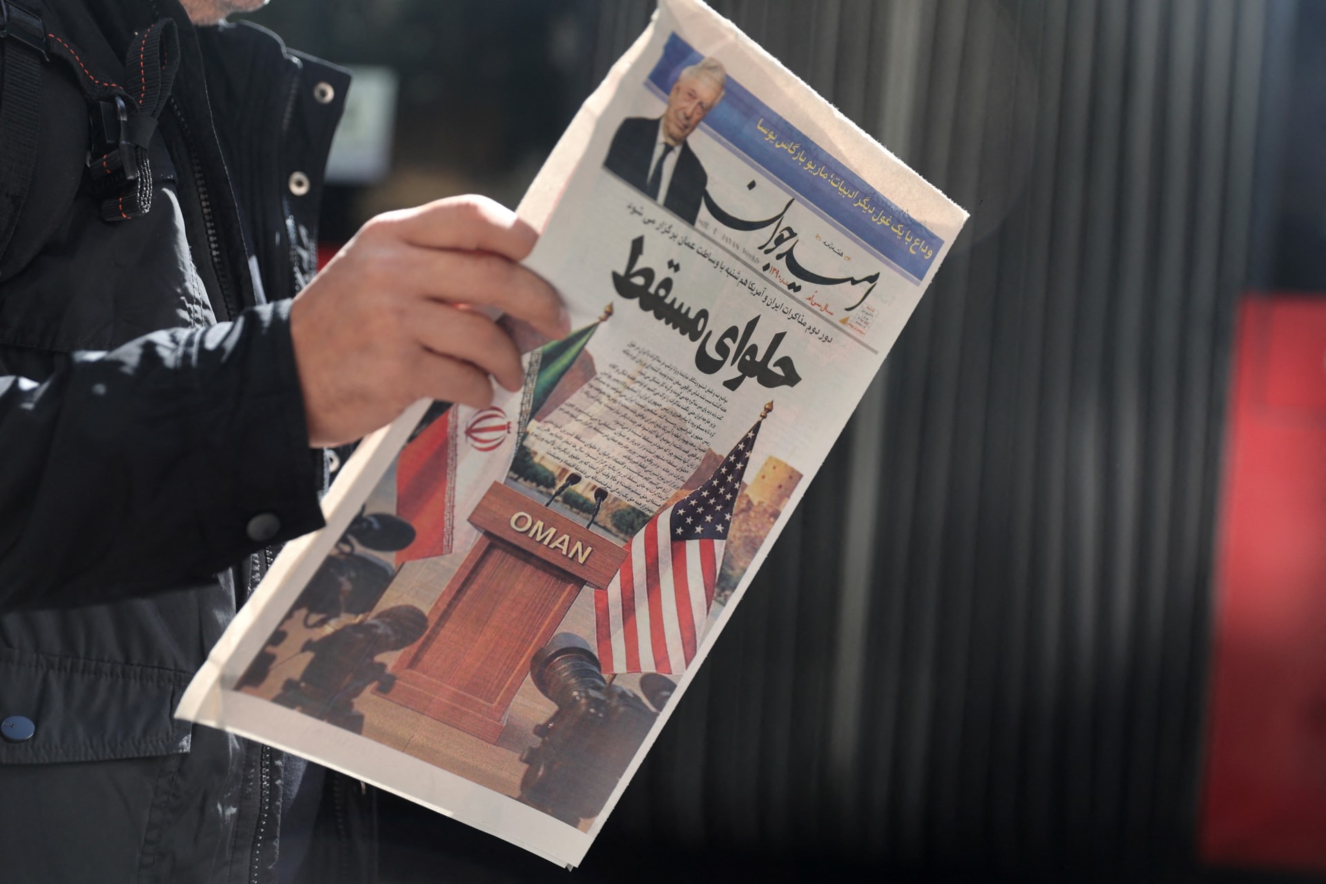 <p>An Iranian man holds a newspaper with a cover photo of Iran and U.S. flags on a street in Tehran, Iran, on April 19, 2025.</p>
