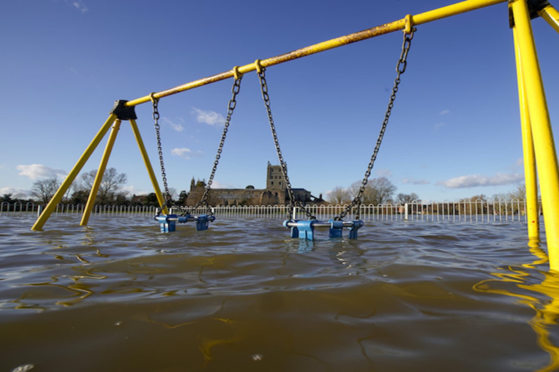 <p>TEWKESBURY, ENGLAND – FEBRUARY 27: Tewkesbury Abbey and a children’s playground at the confluence of the Rivers Severn and Avon, is surrounded by flood waters on February 27, 2020 in Tewskesbury, England. Flooding levels are decreasing after storms Ciara </p>
