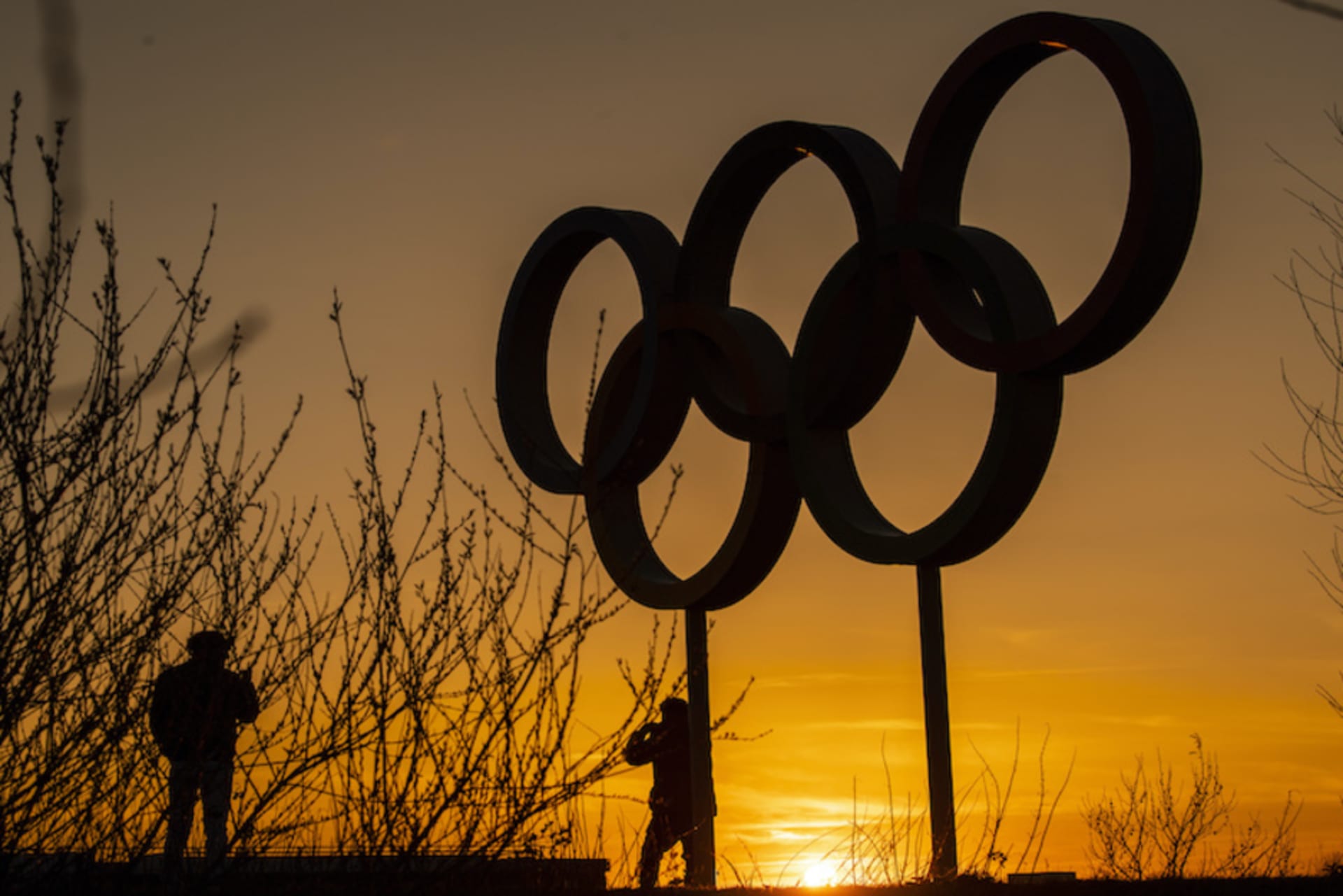 <p>LONDON, UNITED KINGDOM- MARCH 23: People pose for pictures in front of the Olympic rings in the Olympic Park in Stratford as Tokyo Olympics organisers are considering options to delay the Olympics with teams treating to pull out due to the coronavirus on </p>
