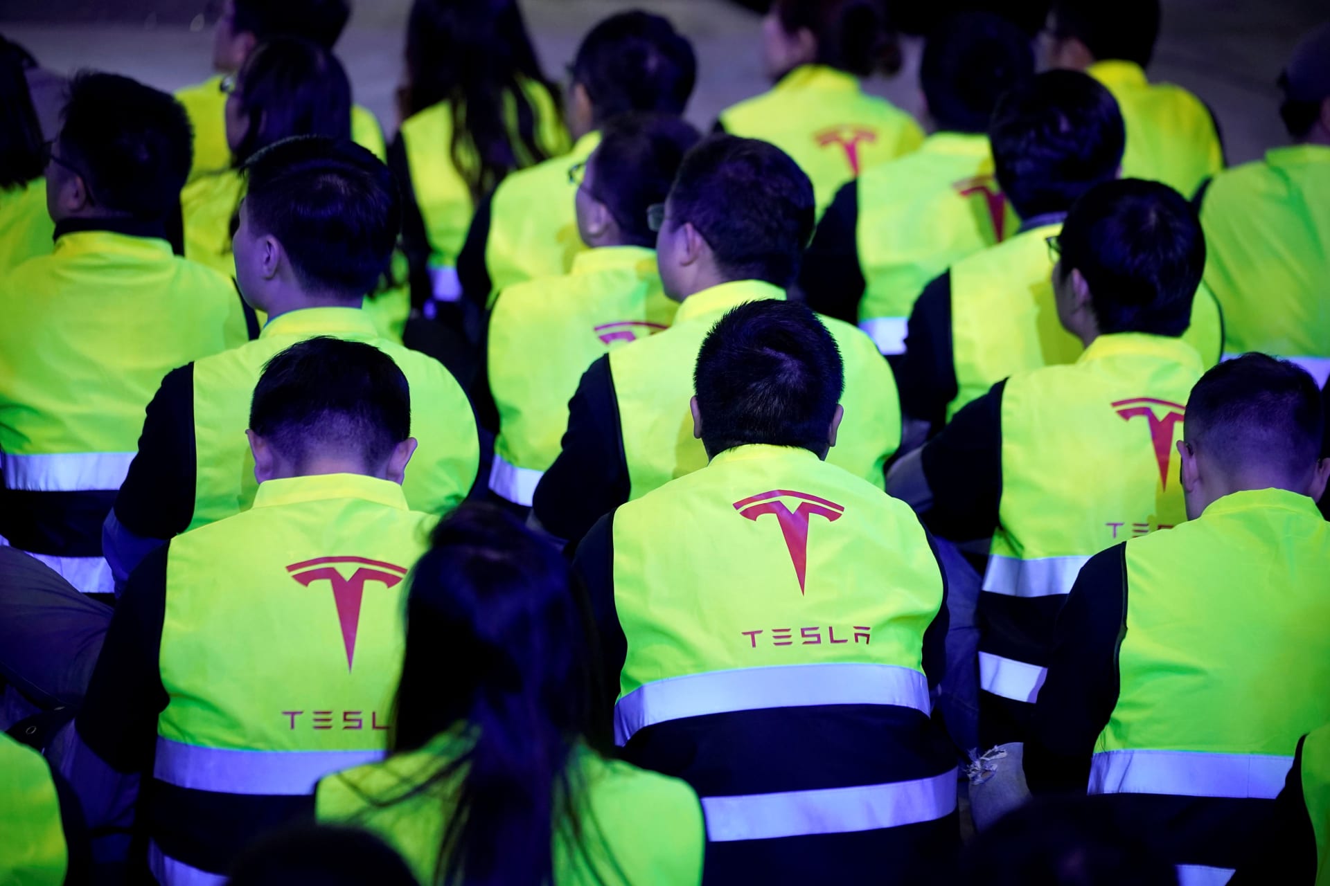 <p>Employees of Tesla are seen during a delivery event for Tesla China-made Model 3 cars in Shanghai</p>
