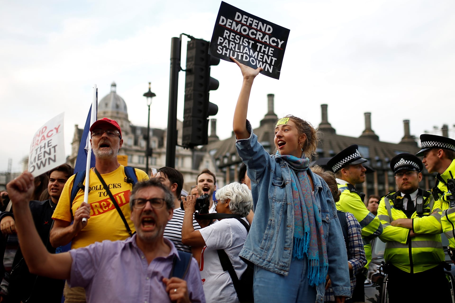 <p>Anti-Brexit protestors hold placards outside the Houses of Parliament in London</p>