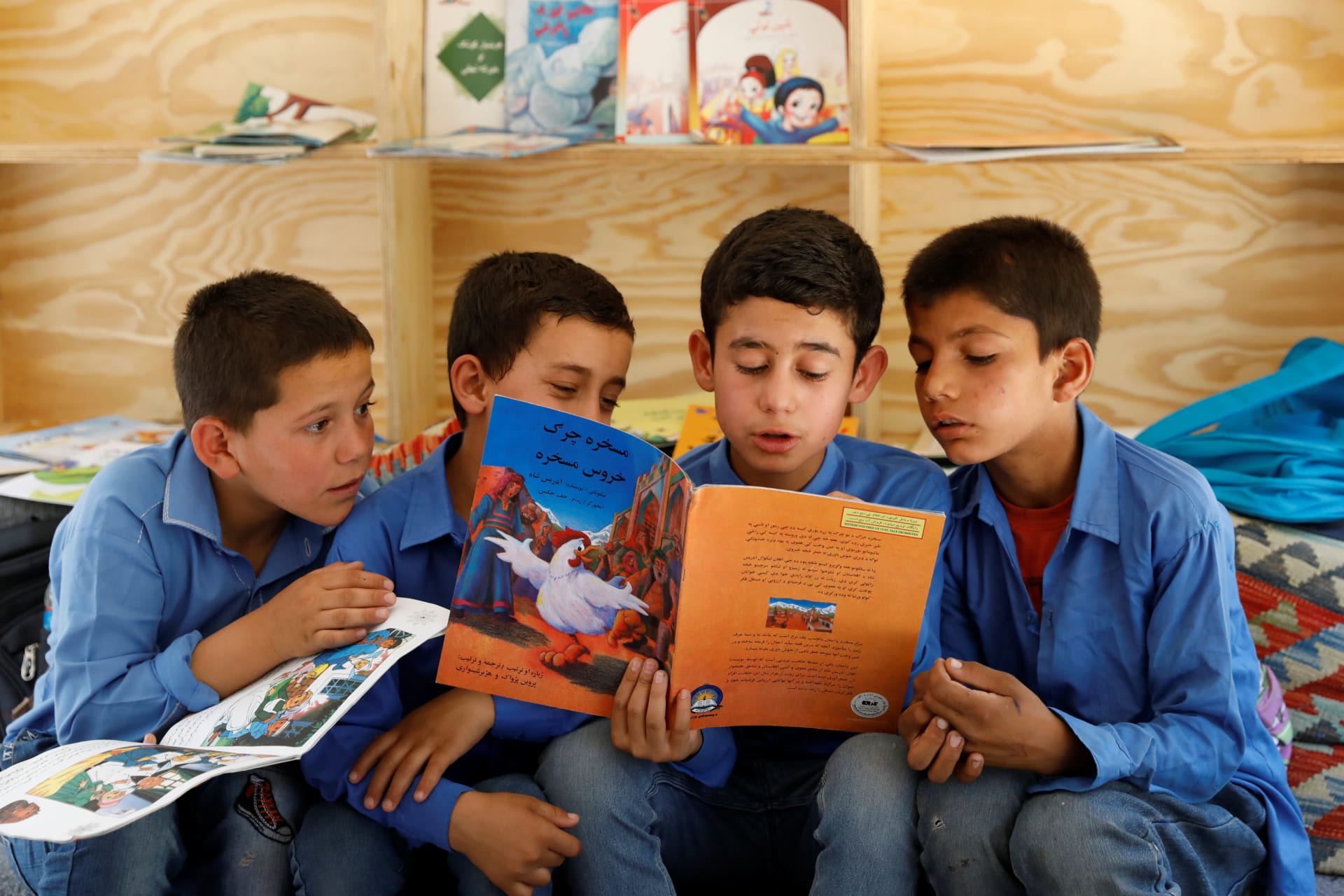 <p>Afghan boys reading inside a mobile library bus in Kabul, Afghanistan.</p>
