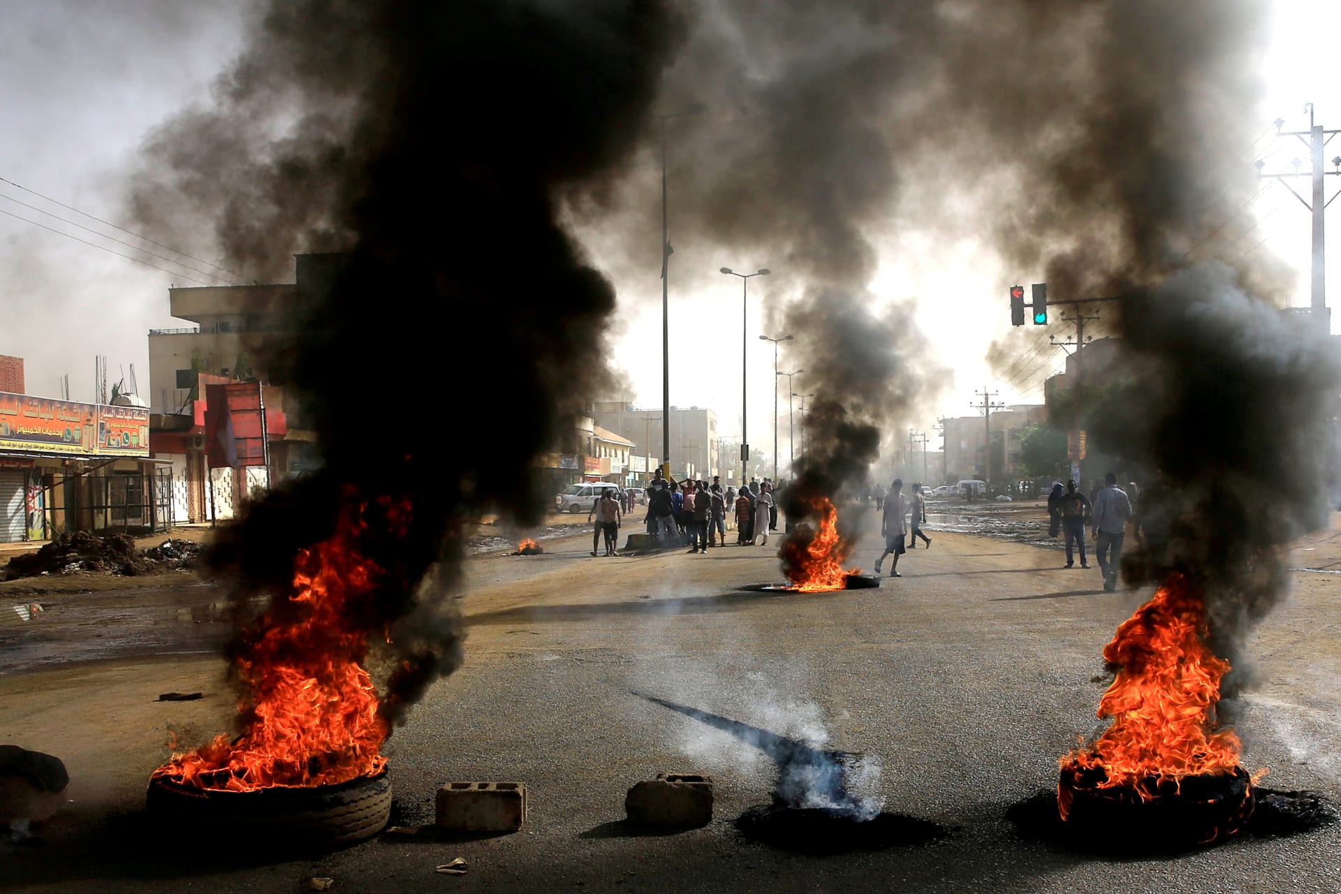 <p>Sudanese protesters use burning tires as a barricade in Khartoum.</p>
