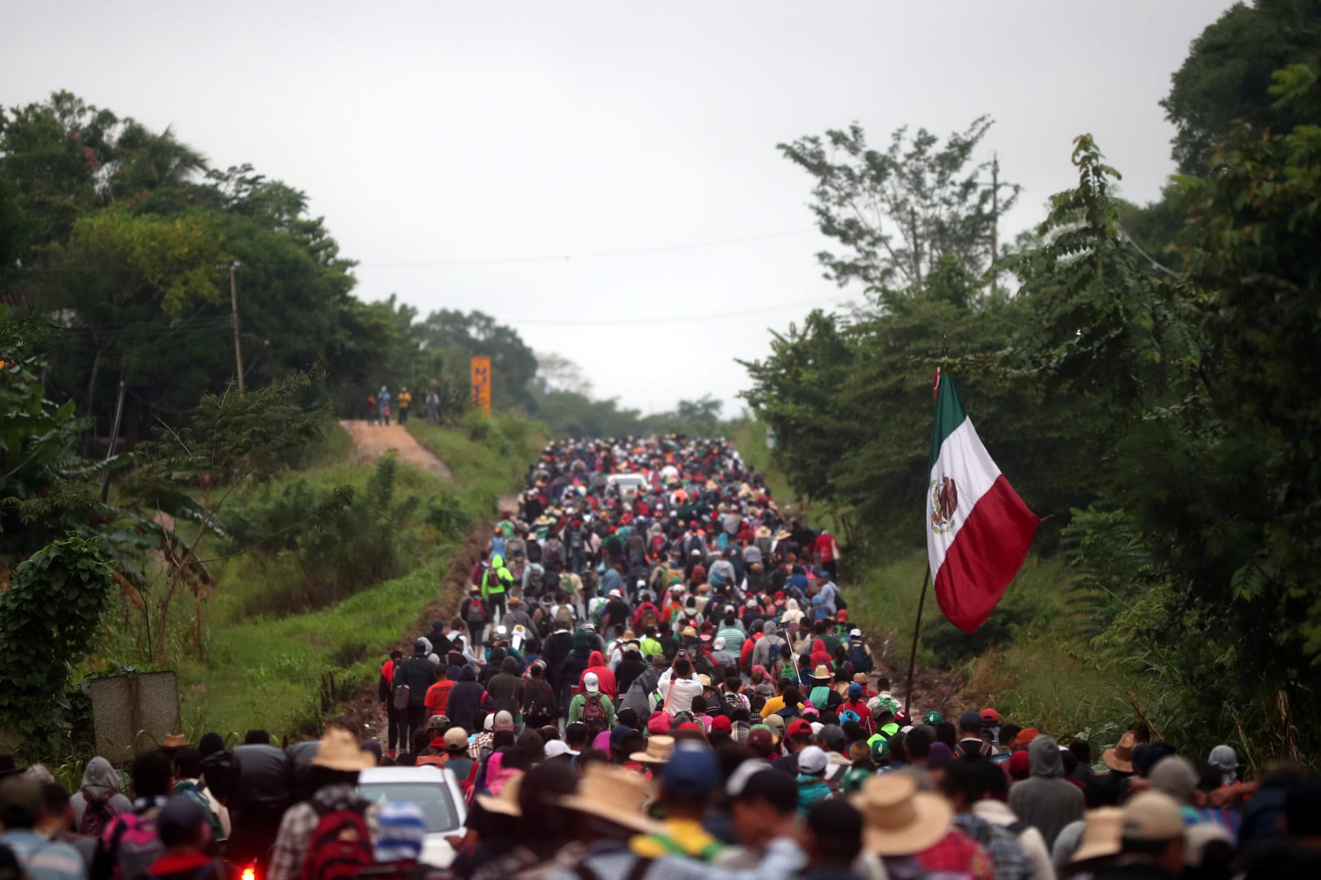 <p>Central Americans en route to the United States walk along a highway in Mexico.</p>
