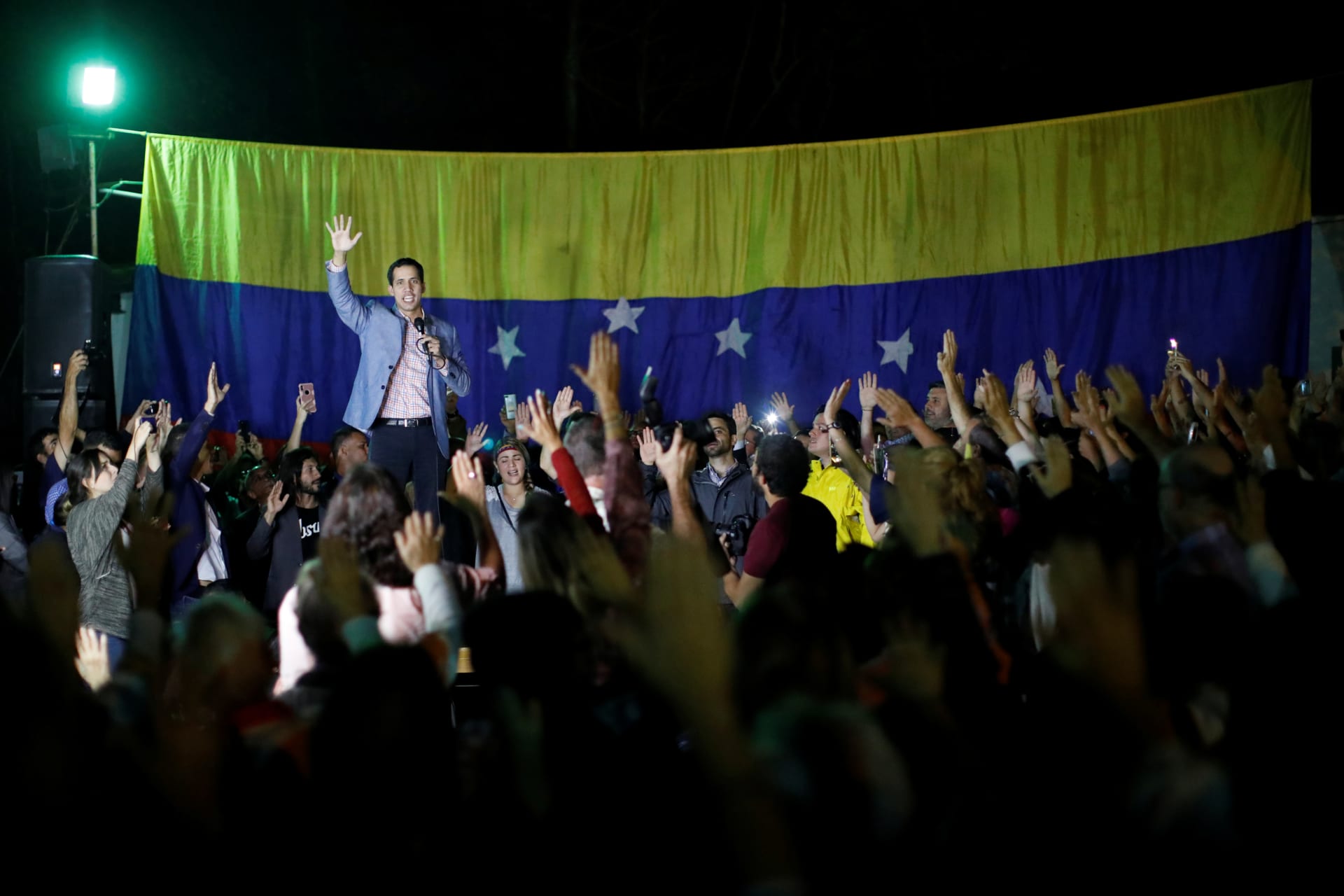 <p>Juan Guaido, President of Venezuela’s National Assembly, raises his hand while he speaks during a gathering in Caracas, Venezuela January 16, 2019.</p>
