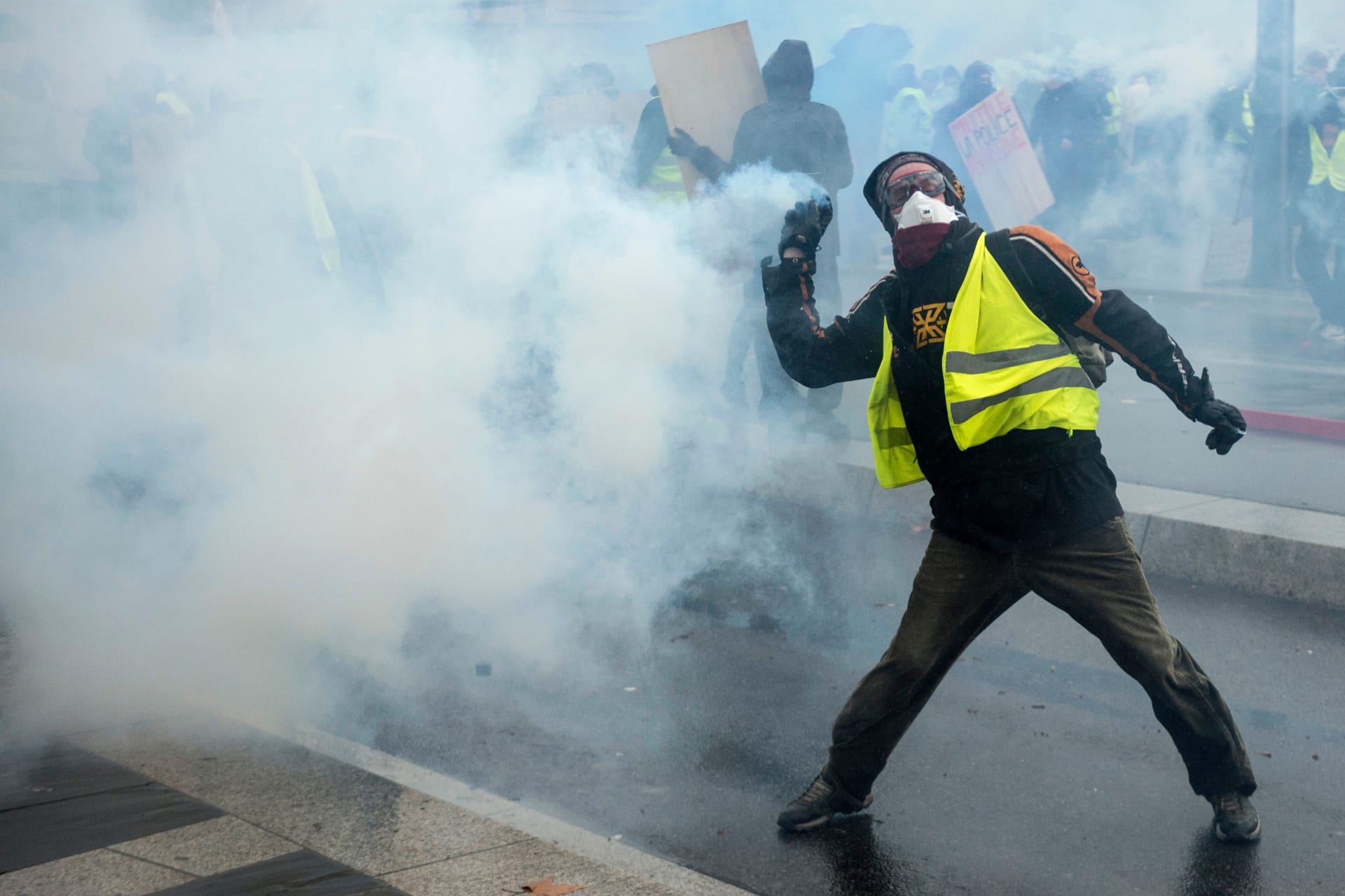 <p>A Yellow Vests protester throws a tear gas canister in Nantes, France.</p>