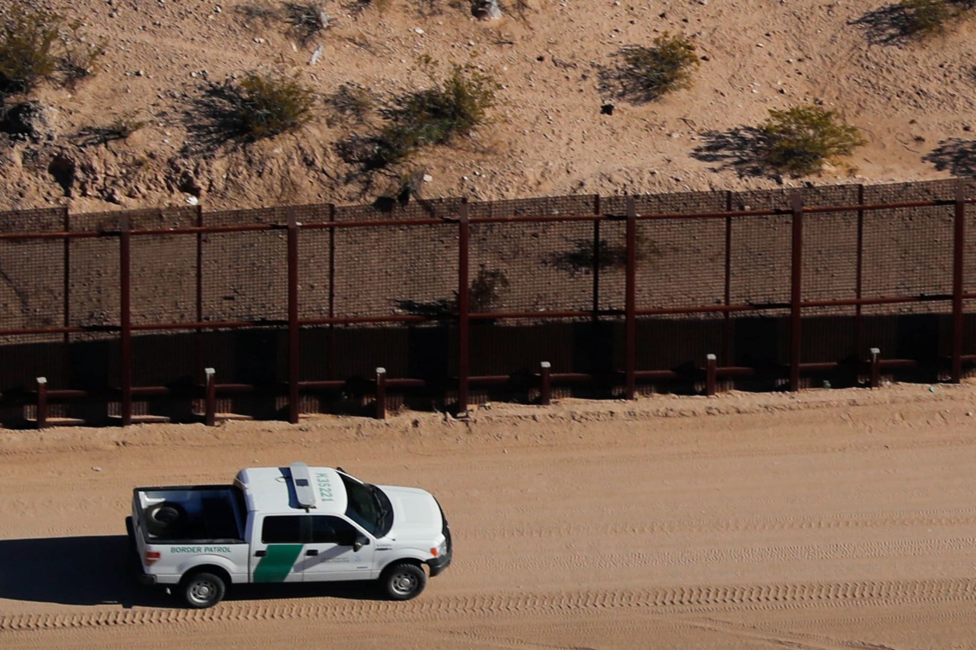 <p>A U.S. border patrol truck drives along the border fence between Mexico and Sunland Park, New Mexico.</p>
