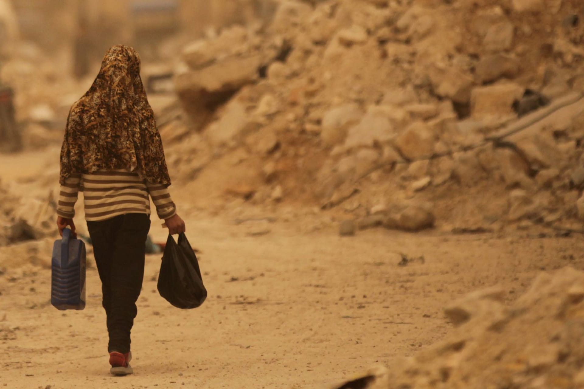 <p>A civilian walks along a street in the northern Syrian town of al-Bab.</p>
