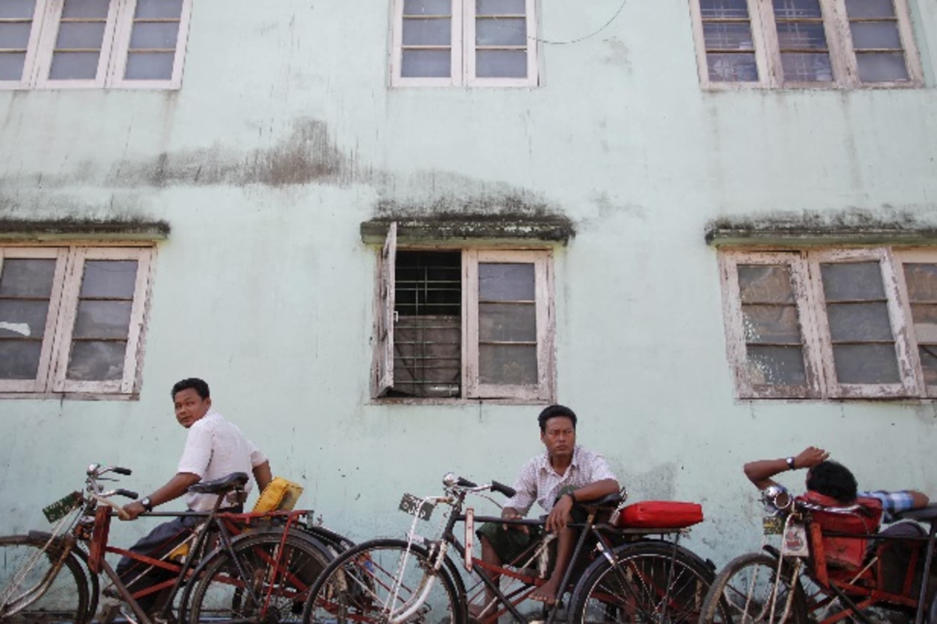 <p>Porters wait for business in an older part of Yangon December 3, 2011. Hours after Hillary Clinton finished the first visit in… military took power in what was then known as Burma in a 1962 coup. To match Insight MYANMAR-INVESTMENT/ REUTERS/Damir Sagolj</p>
