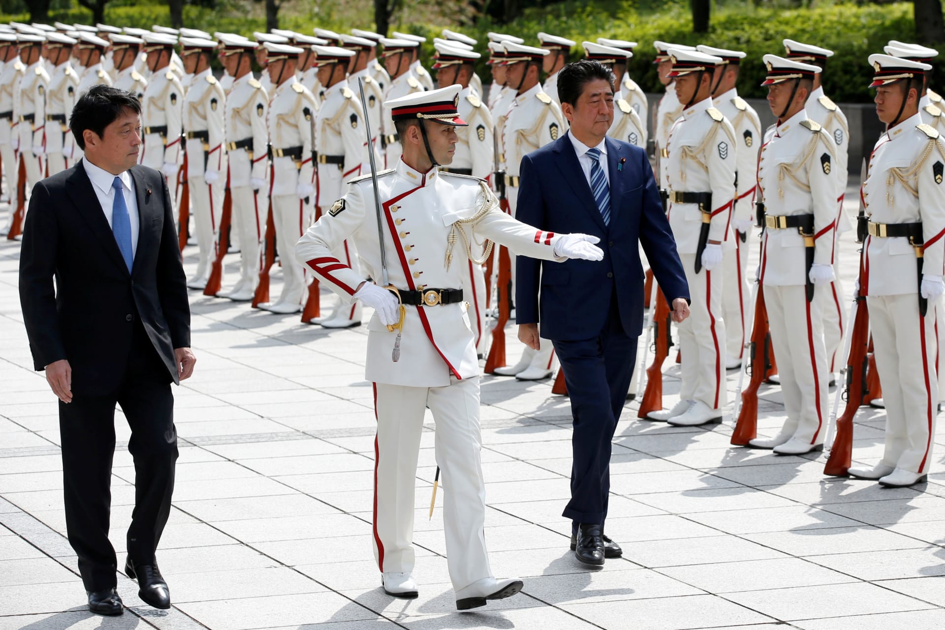 Japan's Prime Minister Shinzo Abe (R) and Defense Minister Itsunori Onodera (L) review the honour guard before a meeting with Japan Self-Defense Force's senior members at the Defense Ministry in Tokyo, Japan, September 11, 2017.