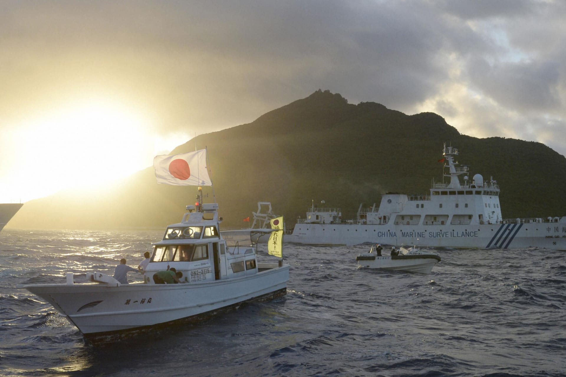 Chinese marine surveillance ship Haijian No. 51 sails near Japan Coast Guard vessels and a Japanese fishing boat in the East China Sea on July 1, 2013.