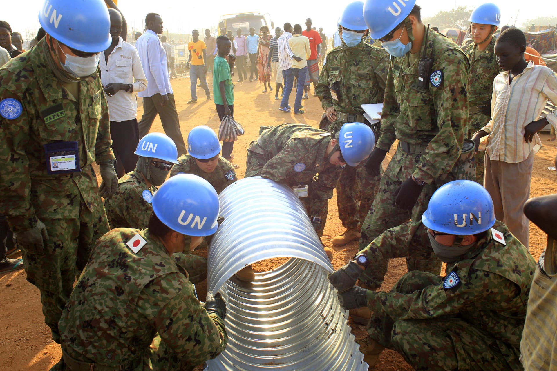United Nations Mission in South Sudan peacekeepers from Japan assemble a drainage pipe at Tomping camp, where some 15,000 people who fled their homes following recent fighting are sheltered by the United Nations, in Juba January 7, 2014.