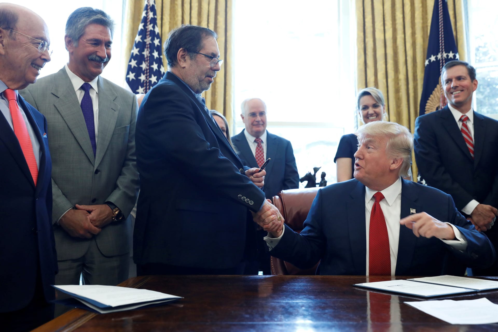 <p>President Donald Trump hands Leo Gerard, president of the United Steelworkers, his pen after signing a directive ordering an investigation into the impact of foreign steel on the U.S. economy.</p>
