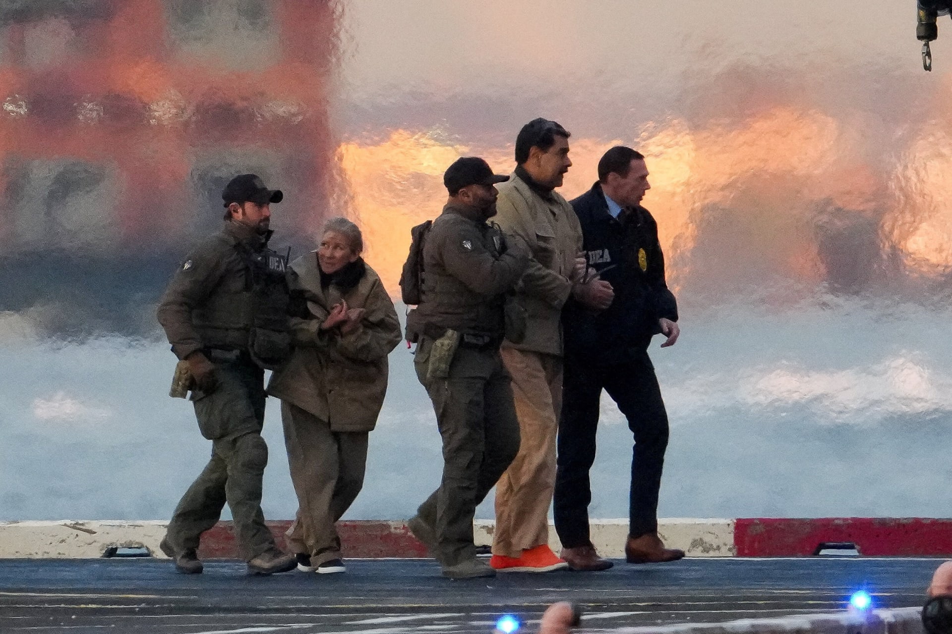 Law enforcement officials move captured Venezuelan President Nicolas Maduro as he heads for an initial appearance to face U.S. federal charges in New York City, U.S., January 5, 2026. 