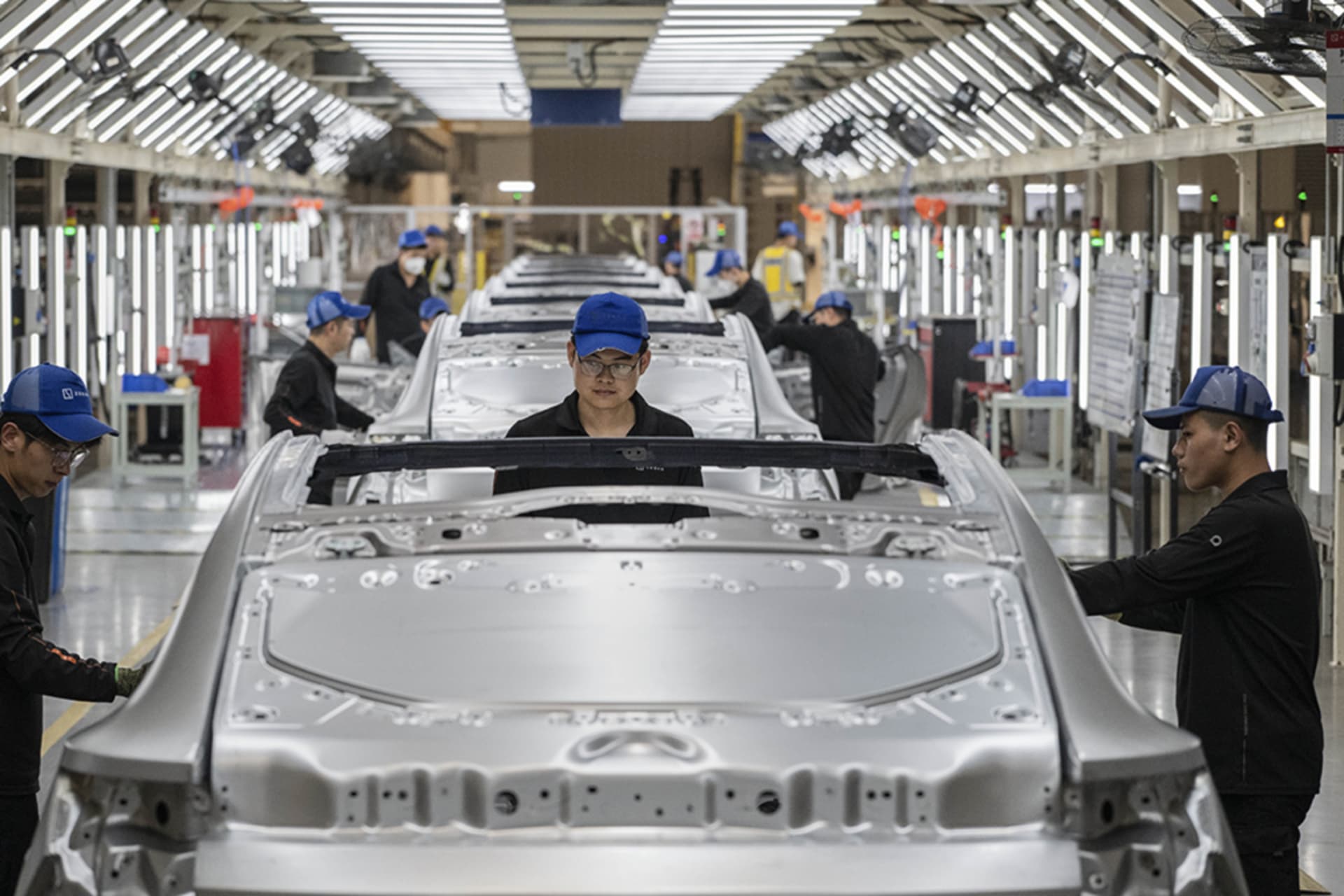 <p>Workers check vehicle frames on the production line for electric vehicle maker Zeekr at its factory in Ningbo, China, on May 29, 2025.</p>
