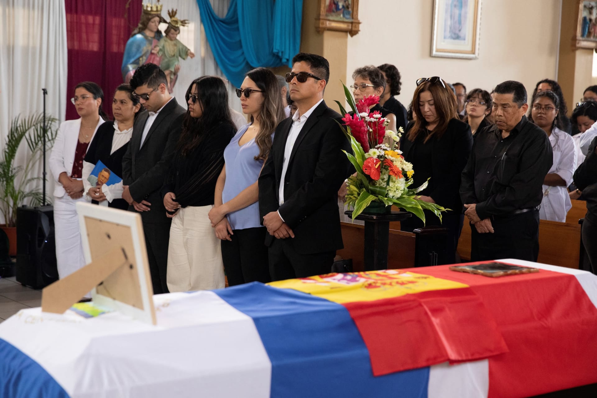 Relatives and friends of an exiled former Nicaraguan military officer attend his funeral