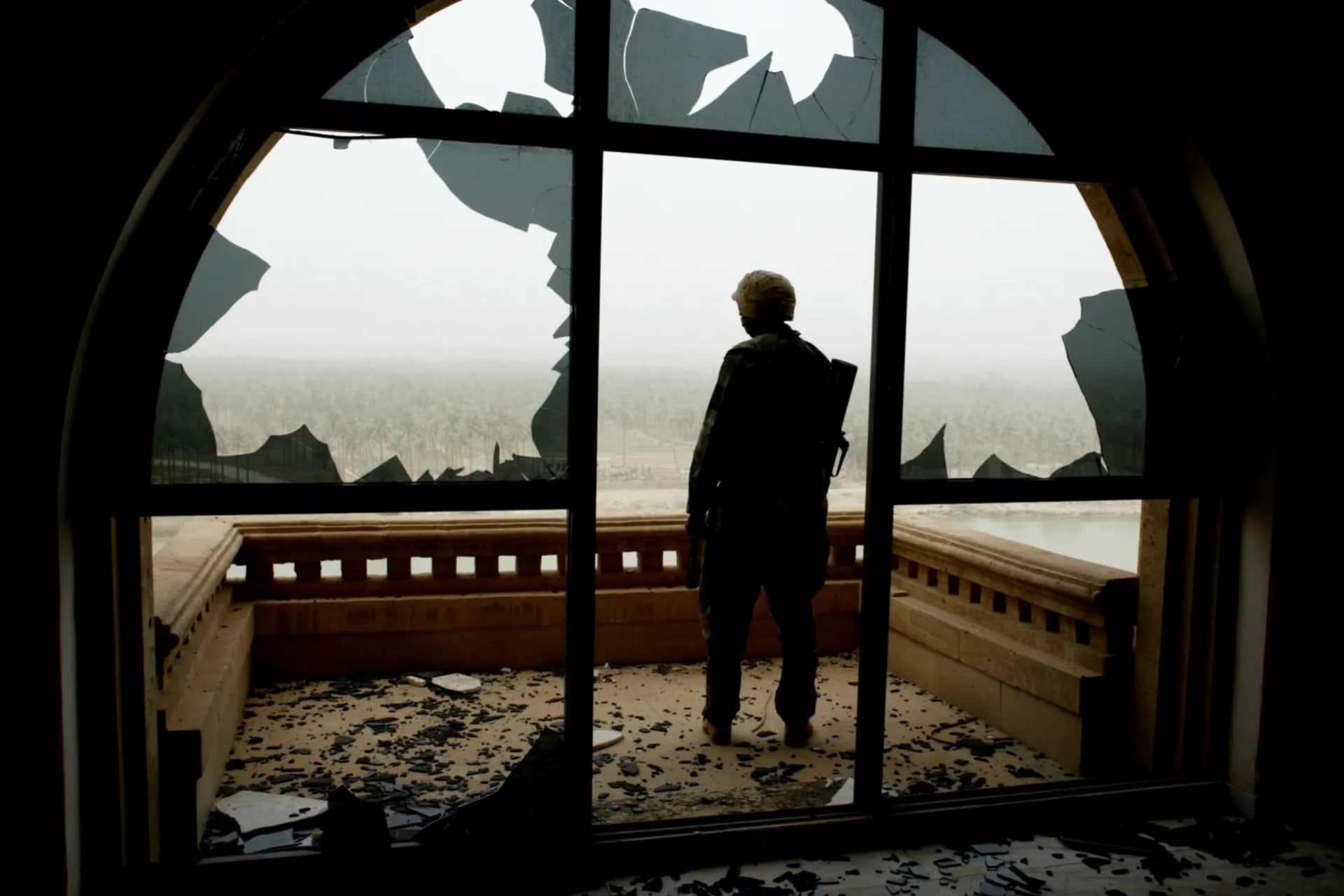 <p>A U.S. marine standing in Saddam Hussein’s palace, Babylon, Iraq, April 2003</p>