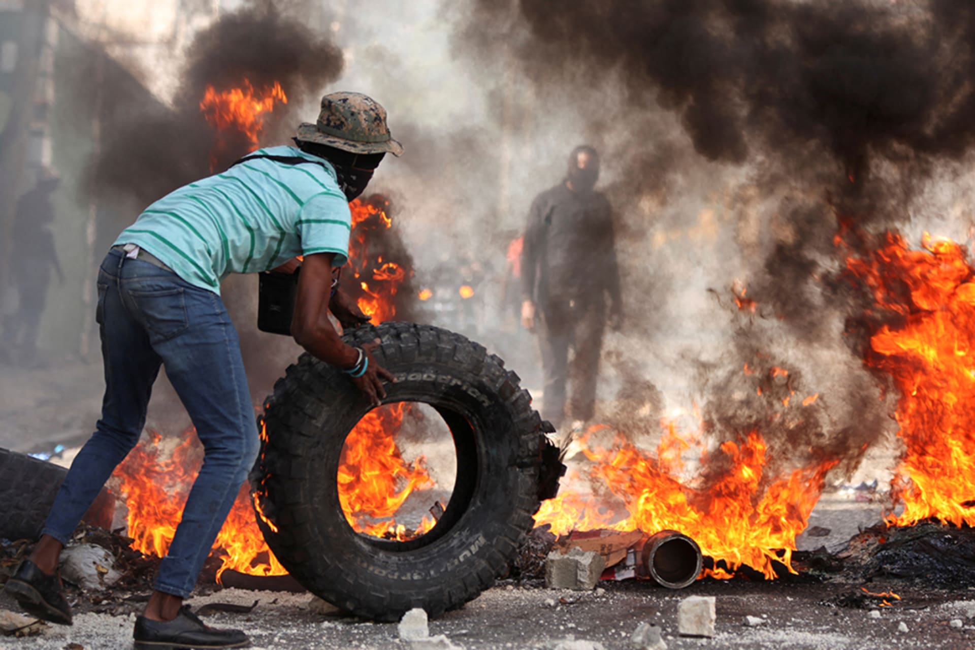 <p>A man adds a tire to a burning barricade during a protest against insecurity in the Pétion-Ville neighborhood of Port-au-Prince, Haiti, on April 2, 2025.</p>
