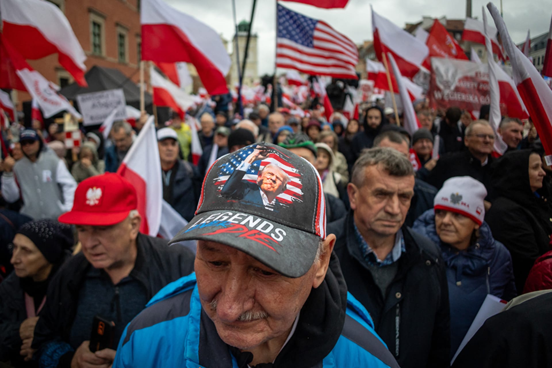 <p>A man wears a cap with a picture of Donald Trump at an anti-immigration demonstration in Warsaw, Poland.</p>
