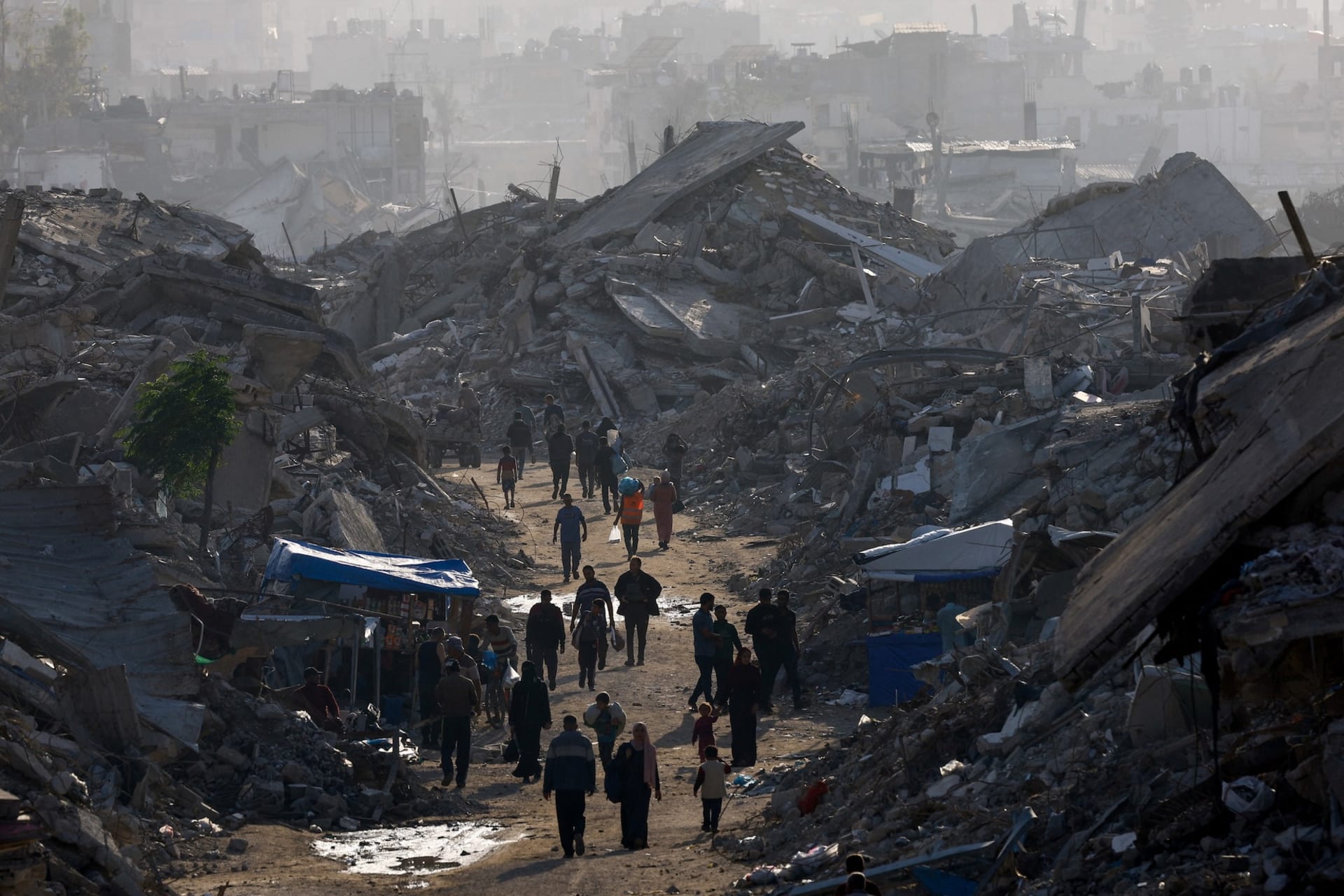 <p>Palestinians walk among piles of rubble, amid a ceasefire between Israel and Hamas, in the northern Gaza Strip November 19, 2025. </p>
