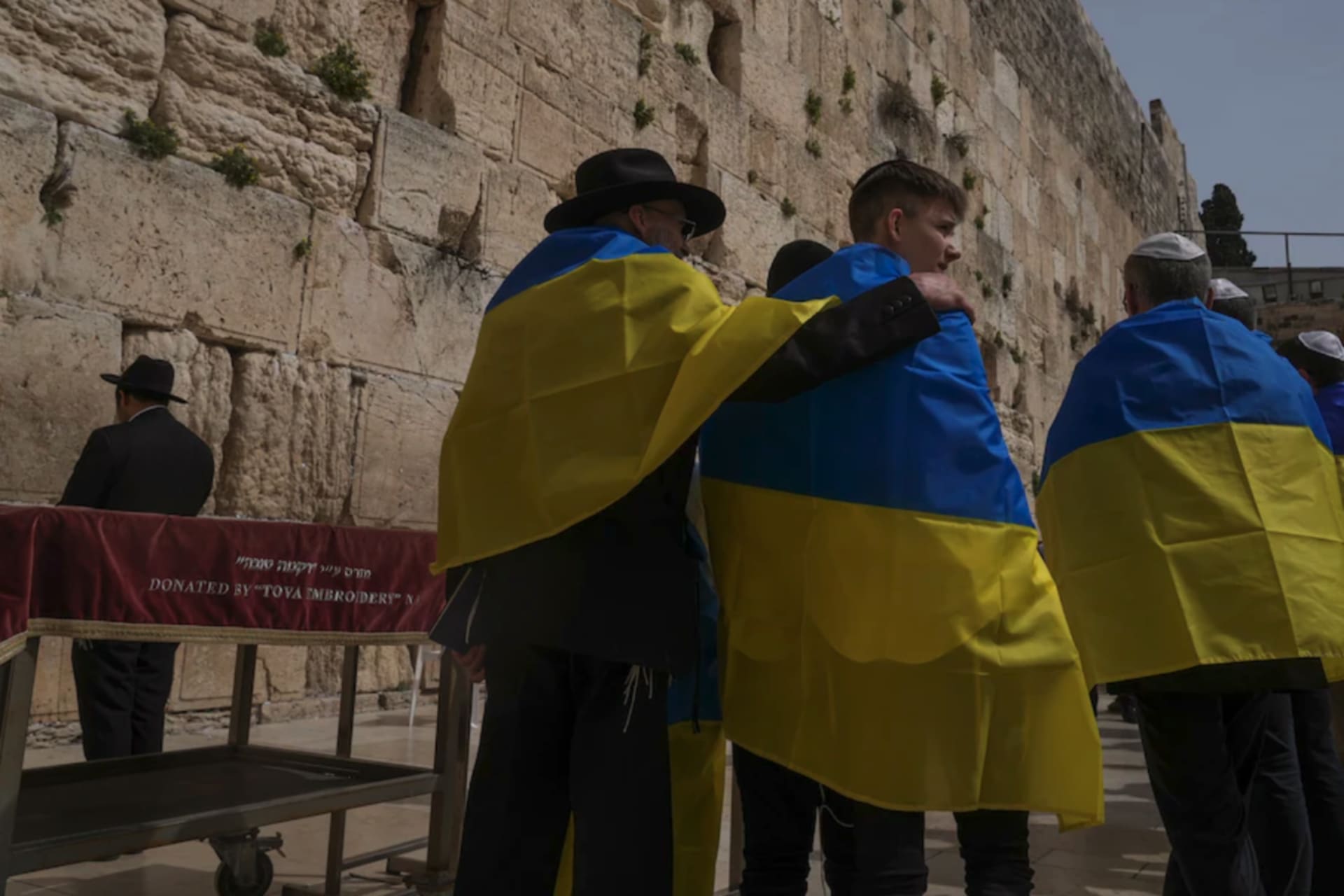 <p>Members of a Ukrainian delegation from Kyiv, wrapped in Ukrainian flags, pray at the Western Wall in Jerusalem’s Old City on April 1. </p>
