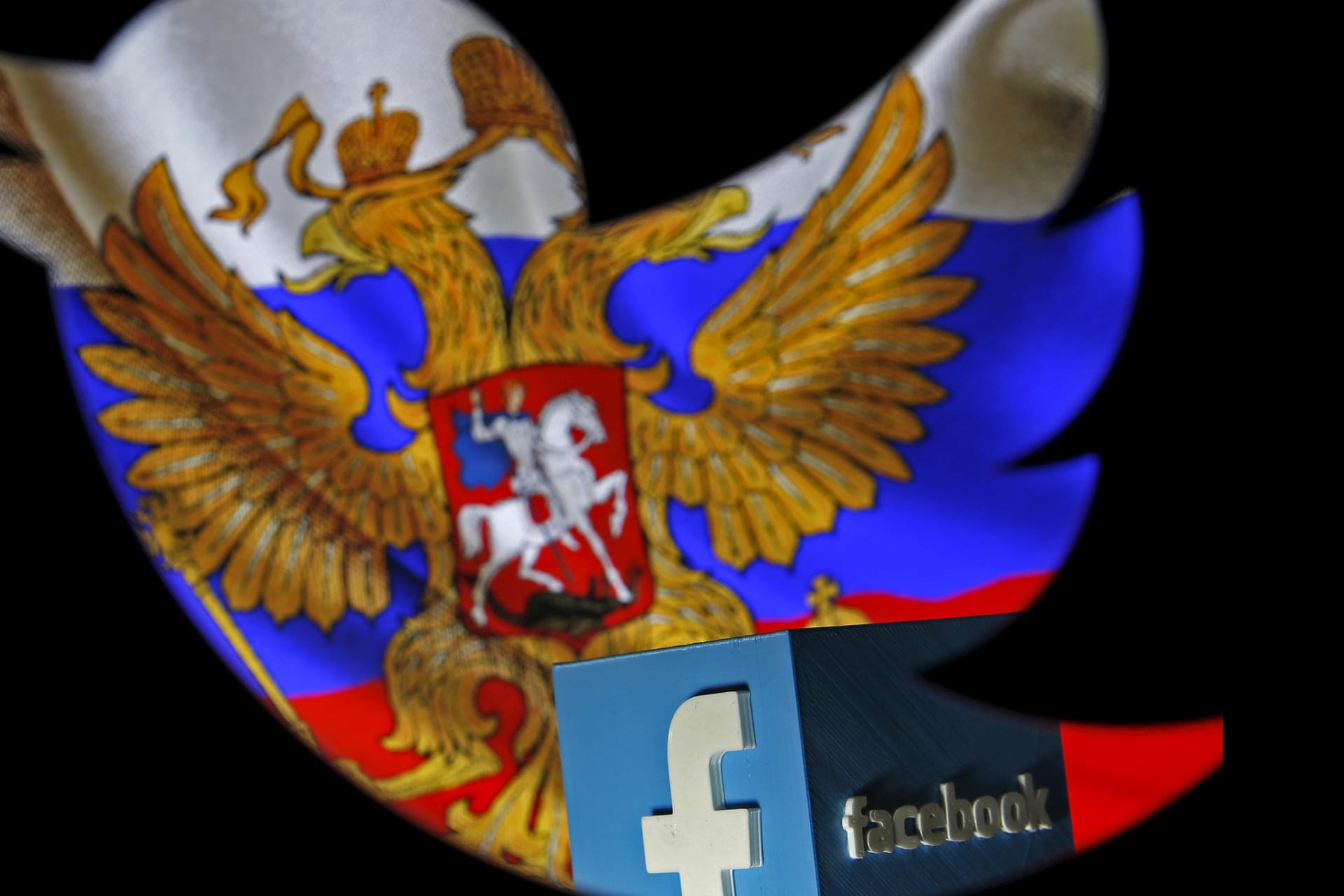 <p>A Russian flag and a 3-D model of the Facebook logo is seen through a cutout of the Twitter logo in this photo illustration taken in Zenica, Bosnia and Herzegovina, on May 22, 2015.</p>
